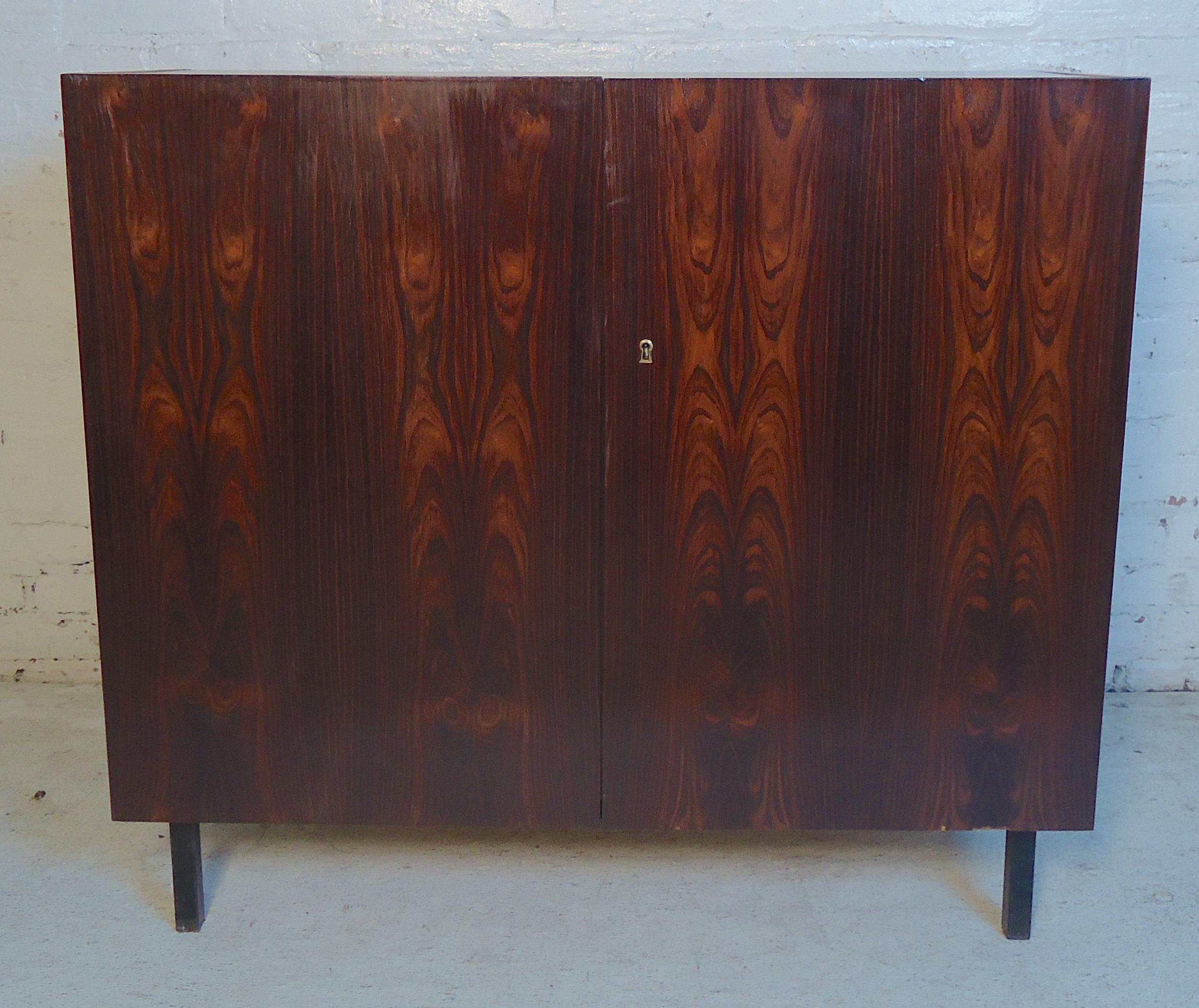 Mid-Century Modern two-door cabinet or dry bar in rosewood grain. 
(Please confirm item location - NY or NJ - with dealer).
 