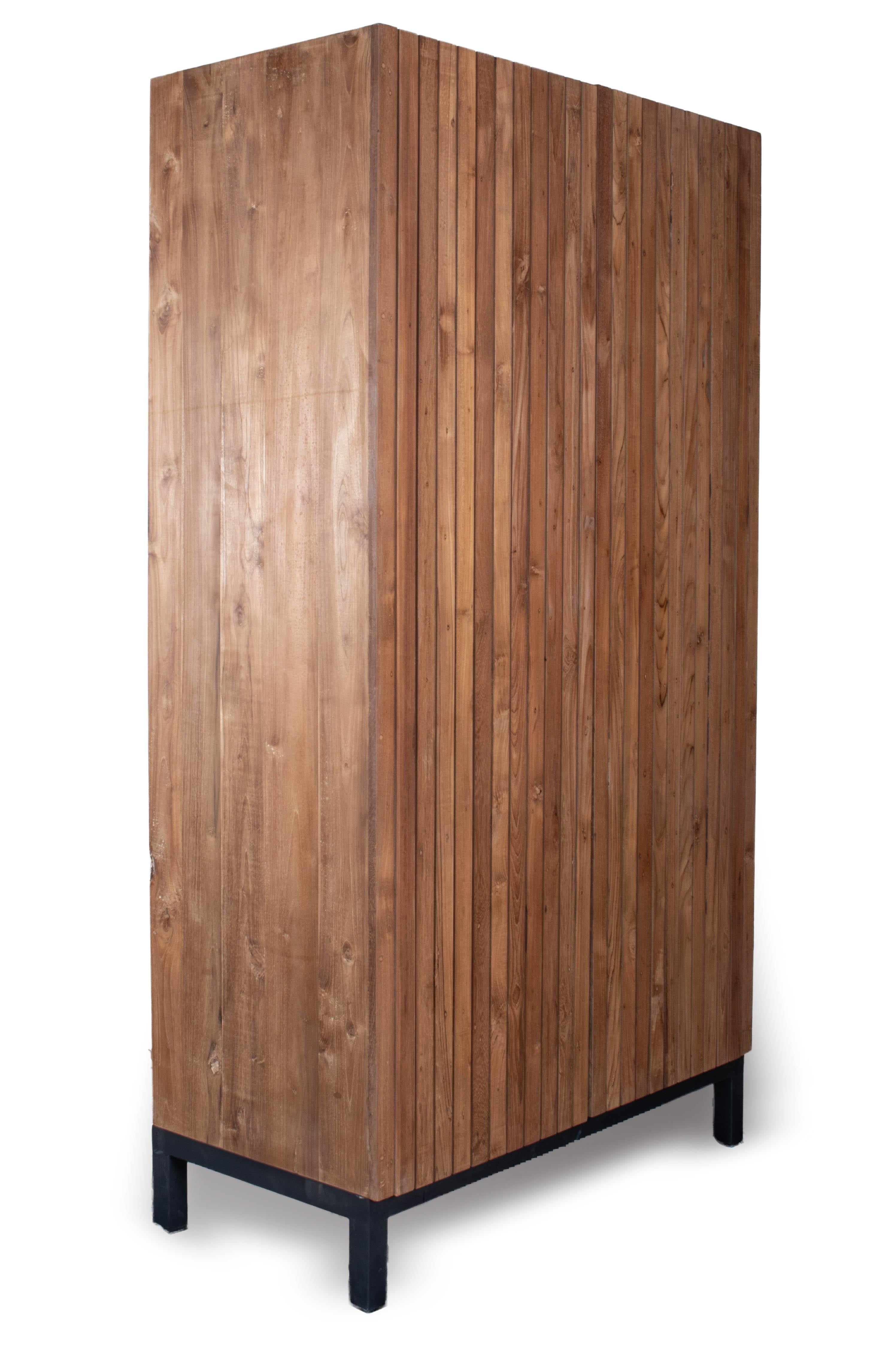 Add a touch of contemporary style to your home with this two-door slat cabinet. The elm wood construction and simple design make this piece a perfect addition to any room, while the versatile interior allows you to reconfigure the storage to meet