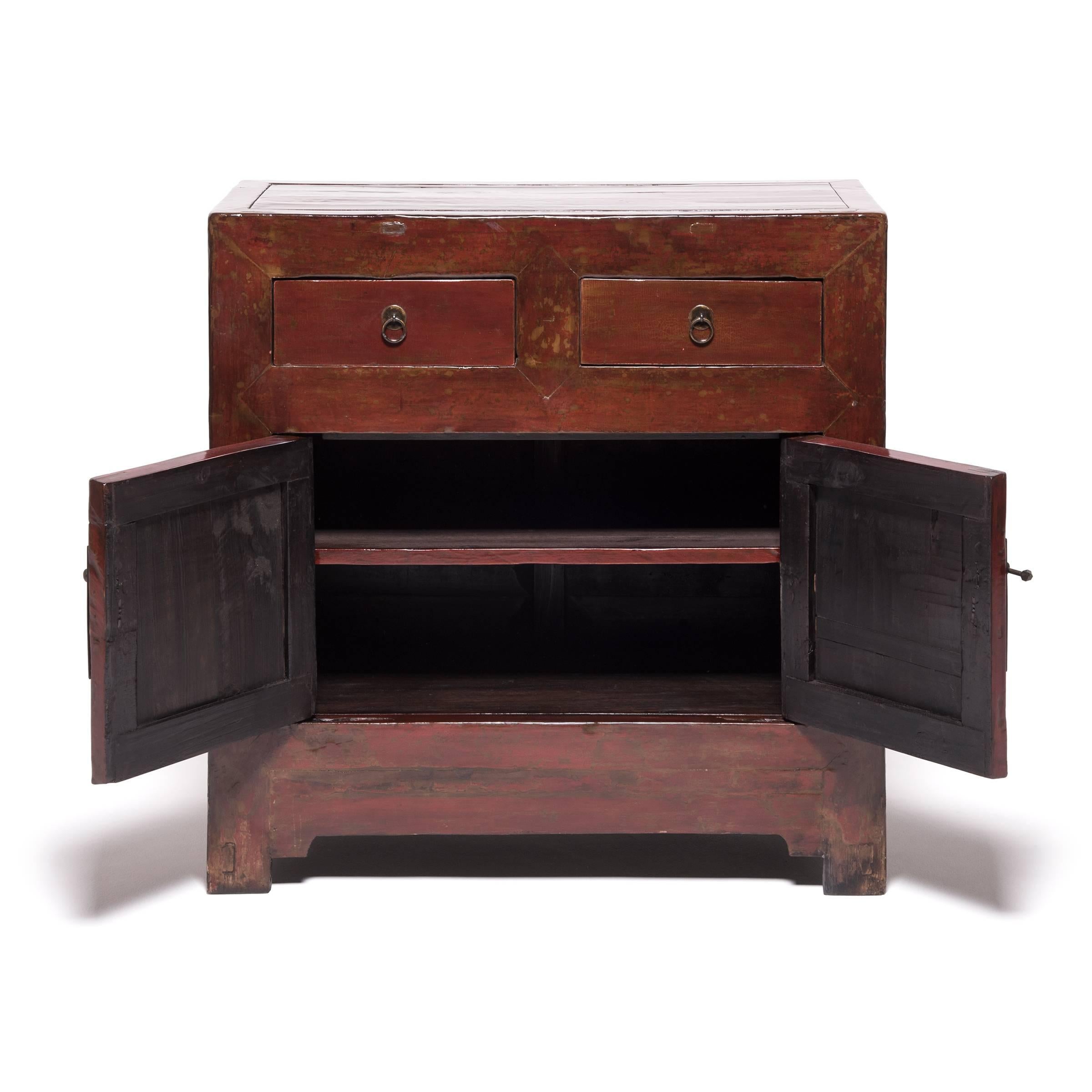 This 19th century chest hailing out of Northern China started its life as a storage trunk with a solid lacquered front. Artisans skilled in traditional Chinese carpentry reconfigured it into a two-door chest and applied additional coats of lacquer,