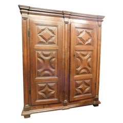 Two-door wardrobe armoires in carved walnut wood, Italy