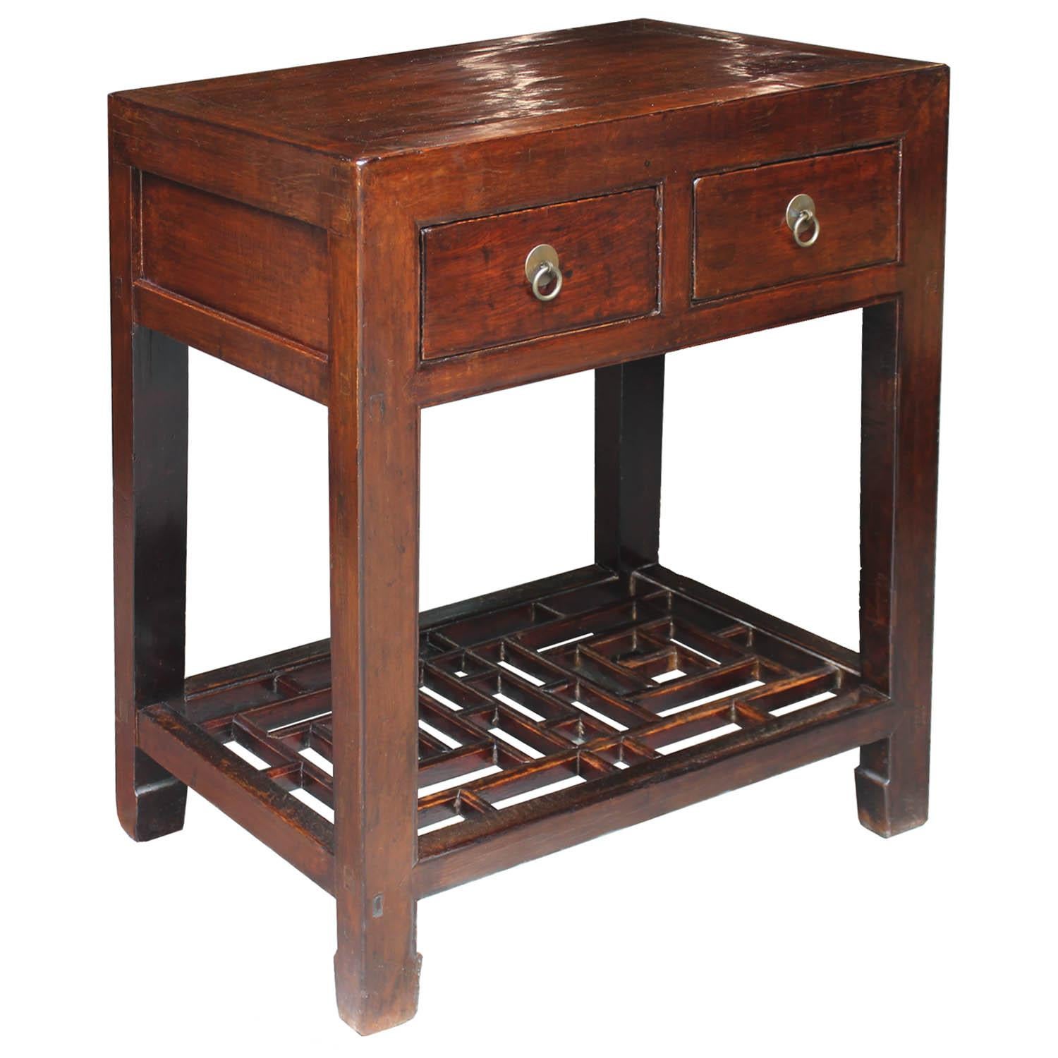 Two-drawer elmwood table with original brown lacquer, latticed bottom shelf and horse hoof-style legs can be used as a bedside table or as a console table in a small hallway. New hardware.