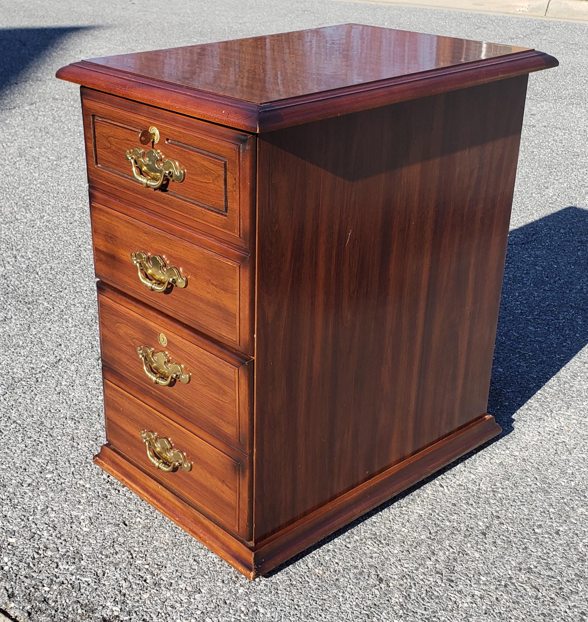 Executive style filing cabinet. Two drawers. Top and bottom drawers lock with key. Comes with one key. Very good vintage condition.