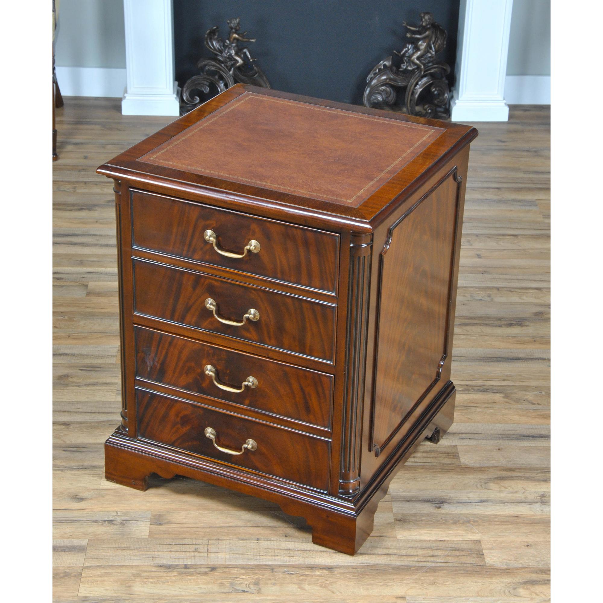 A high quality piece of office furniture from Niagara Furniture our Two Drawer File Cabinet is made with figured mahogany. The top of the cabinet is covered in a full grain brown leather panel which is attractively tooled around the edge with gold
