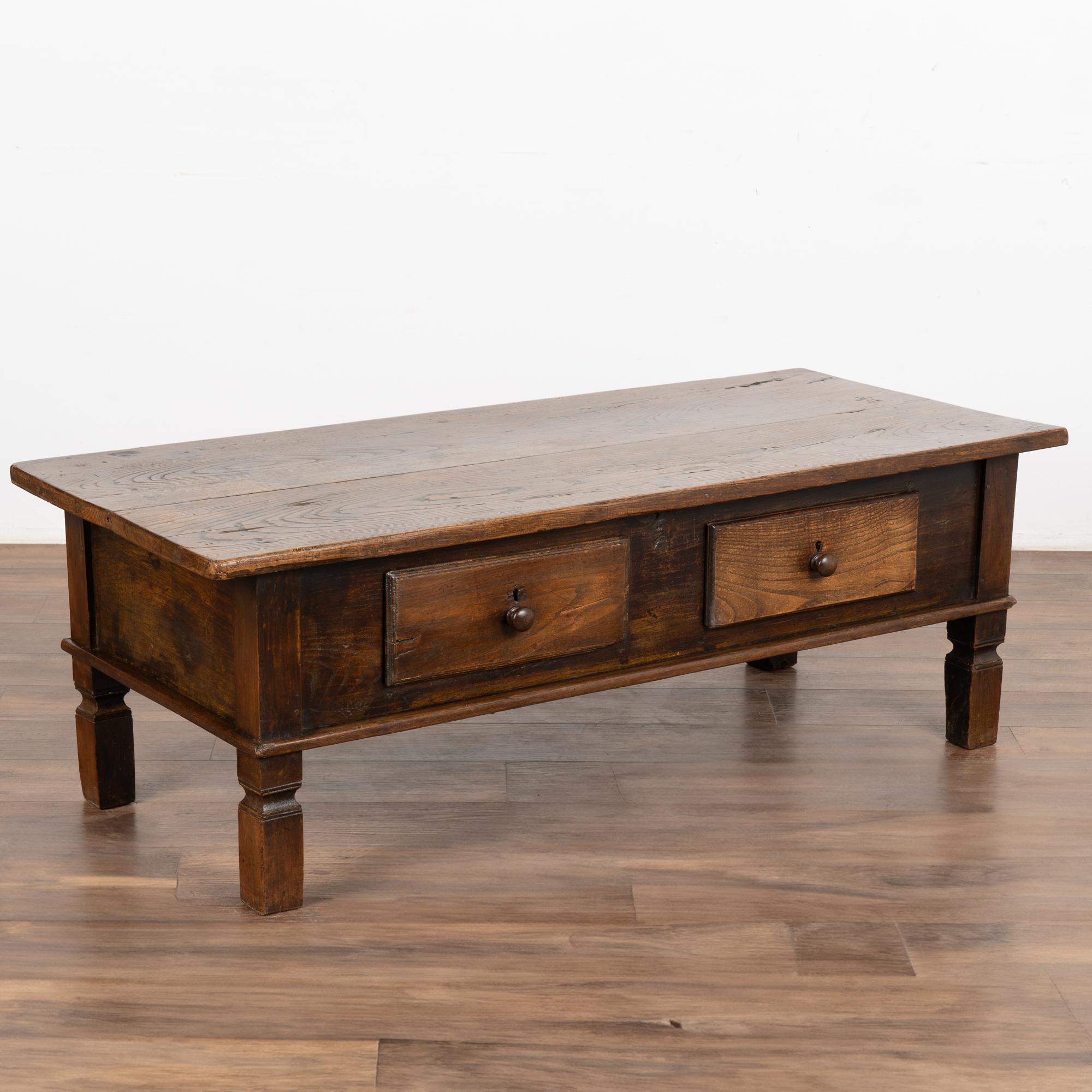 The rustic appeal of this coffee table comes from the aged patina of the worn oak wood. Every scratch, nick, crack and old knarl add to the strong draw of this coffee table Two functional drawers with wooden pulls; 4.5' in length x 2'