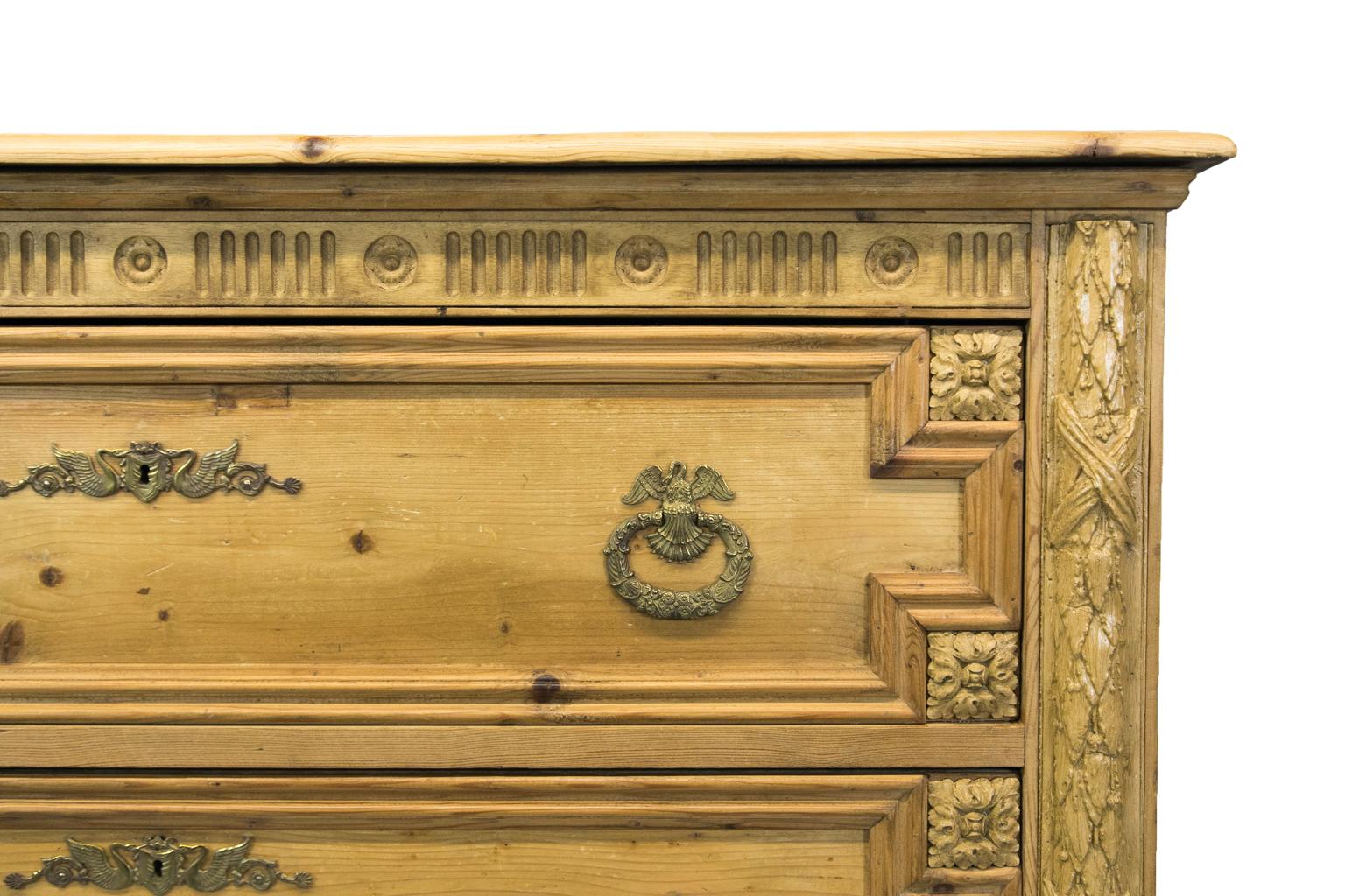 Two-drawer pine chest is made from antique reclaimed pine. There are carved moldings on the front and side panels.
  