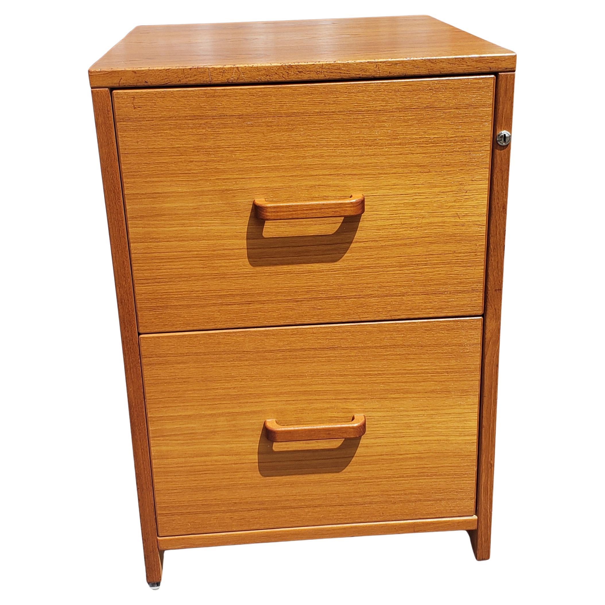 For your consideration sideration is this clean two-drawer teak filing cabinet on wheels. Build in files hanging rail with adjustable separators for legal as well letter size folders. Clean in and out. Very smooth drawers closing and opening.