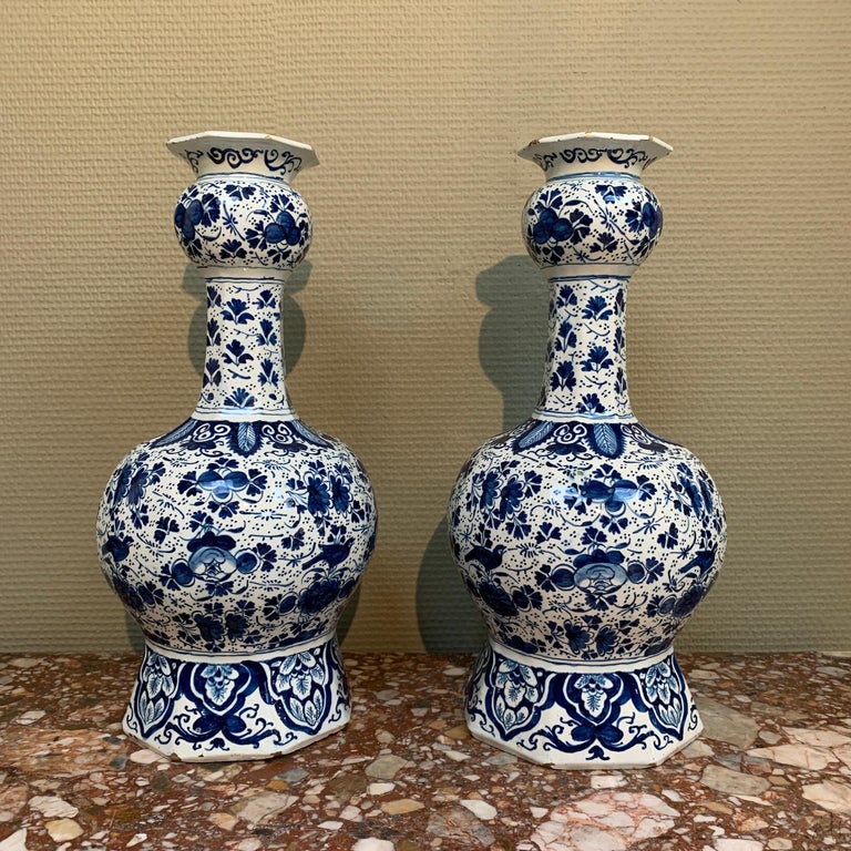 Two Dutch delft baluster vases with floral decor of roses and leaves. 

Place: Delft 
Workshop: De Drie Vergulde Astonne 
Owner: Pieter Gerritsz. Kam 
Date: 1700 - 1716 

Pieter Kam, Son of Gerrit Kam, came from a Delftware family who owned