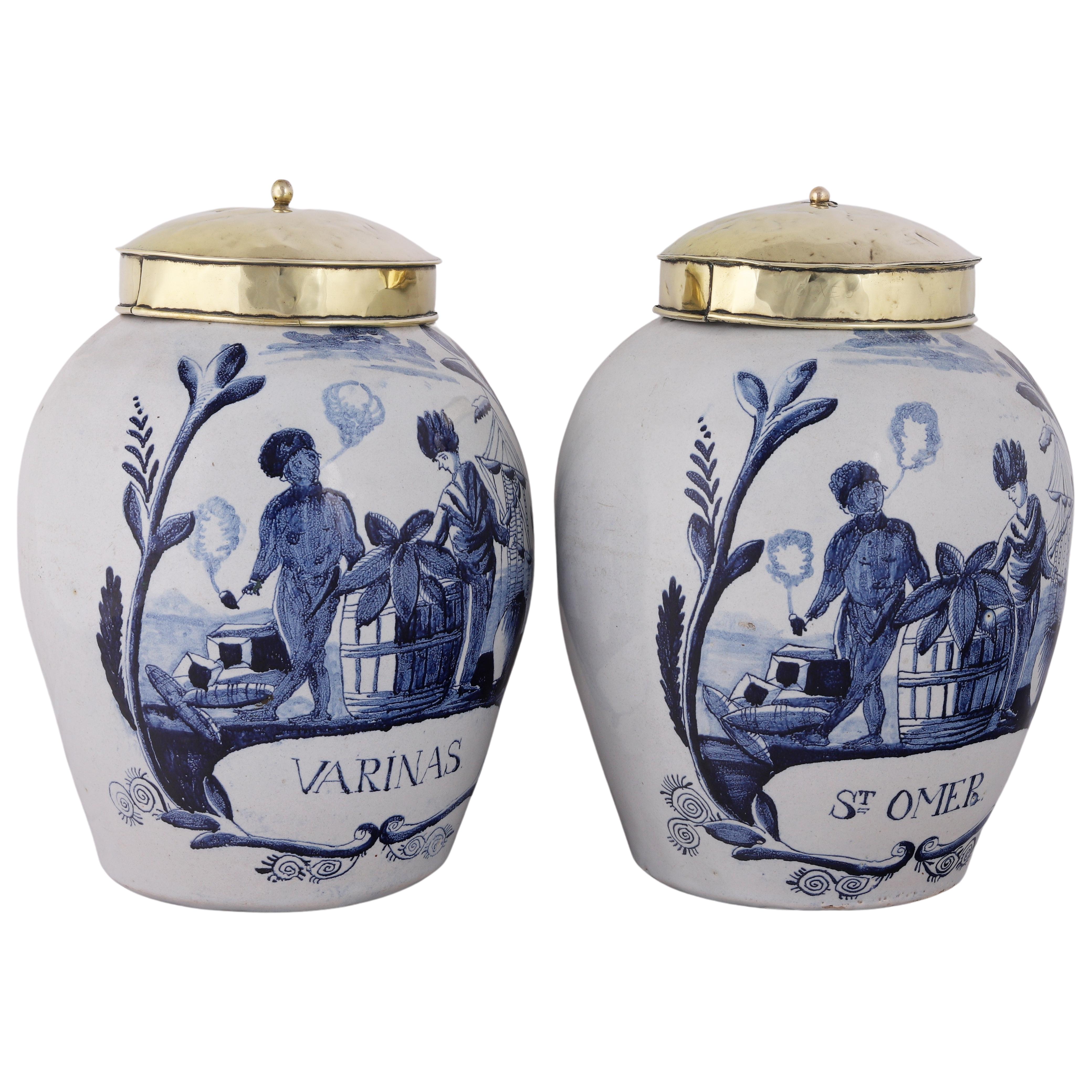 Delft
1760 – 1790
Workshop: De Drie Klokken (The Three Bells)

A genuine set of two blue and white tobacco jar for the storage of tobacco with an original brass lids.
The jars are inscribed Varinas and St. Omer in a cartouche on the base of the jar.