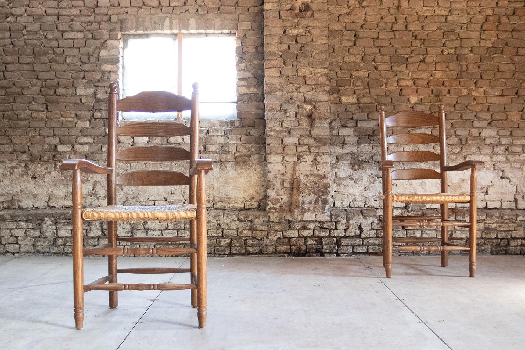 Lovely armchairs from the 1960s made of solid oak with a wicker woven seat.

Fit perfectly with the style of designers such as Charlotte Perriand and Charles Dudouyt.
Comfortable and a very nice warm appearance due to the use of only natural