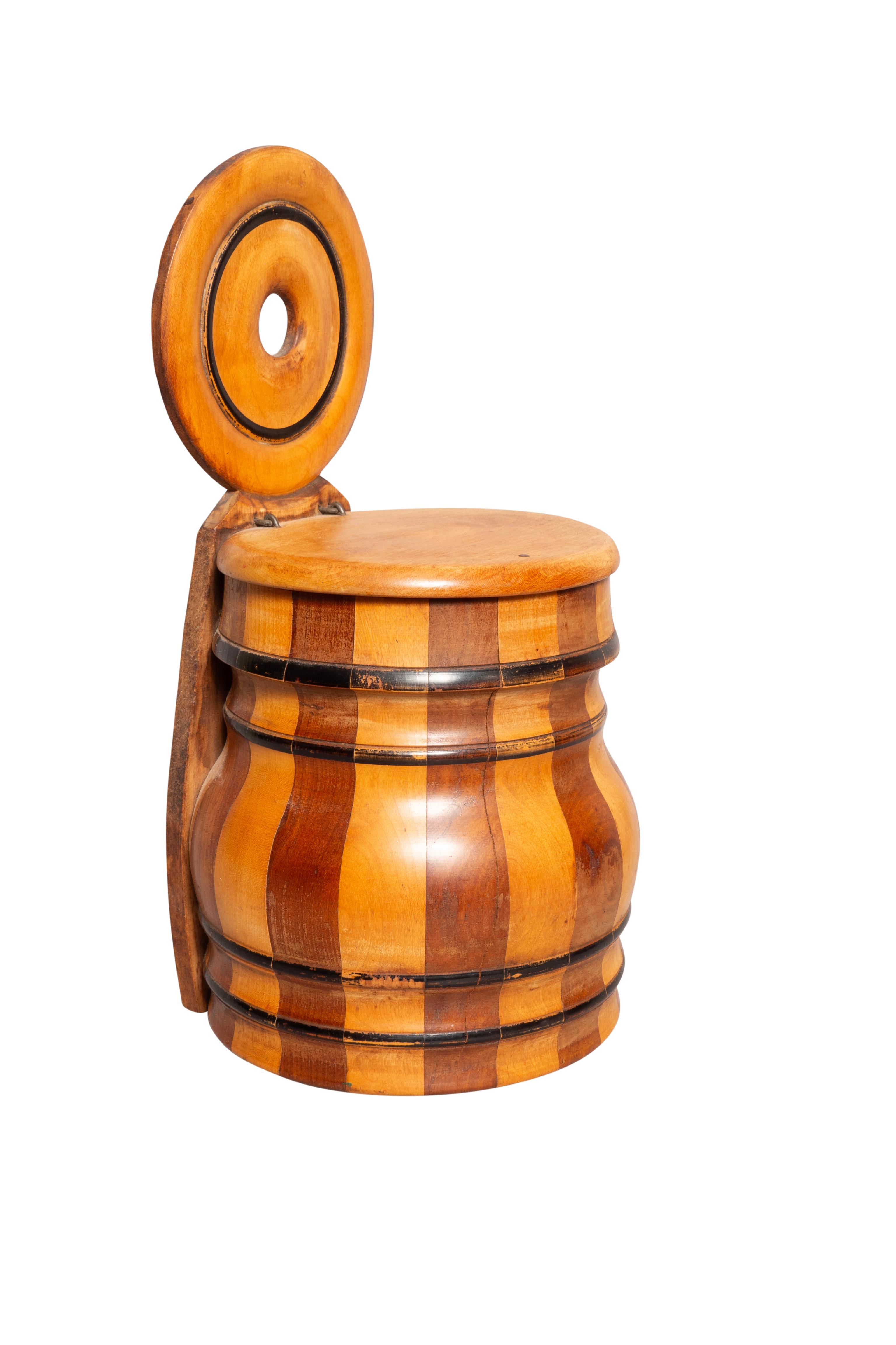 Meant to hang on a wall. Barrel shape with alternating woods. Lift lid and cutout back to hang on a wall. Commonly referred to as treen ware.