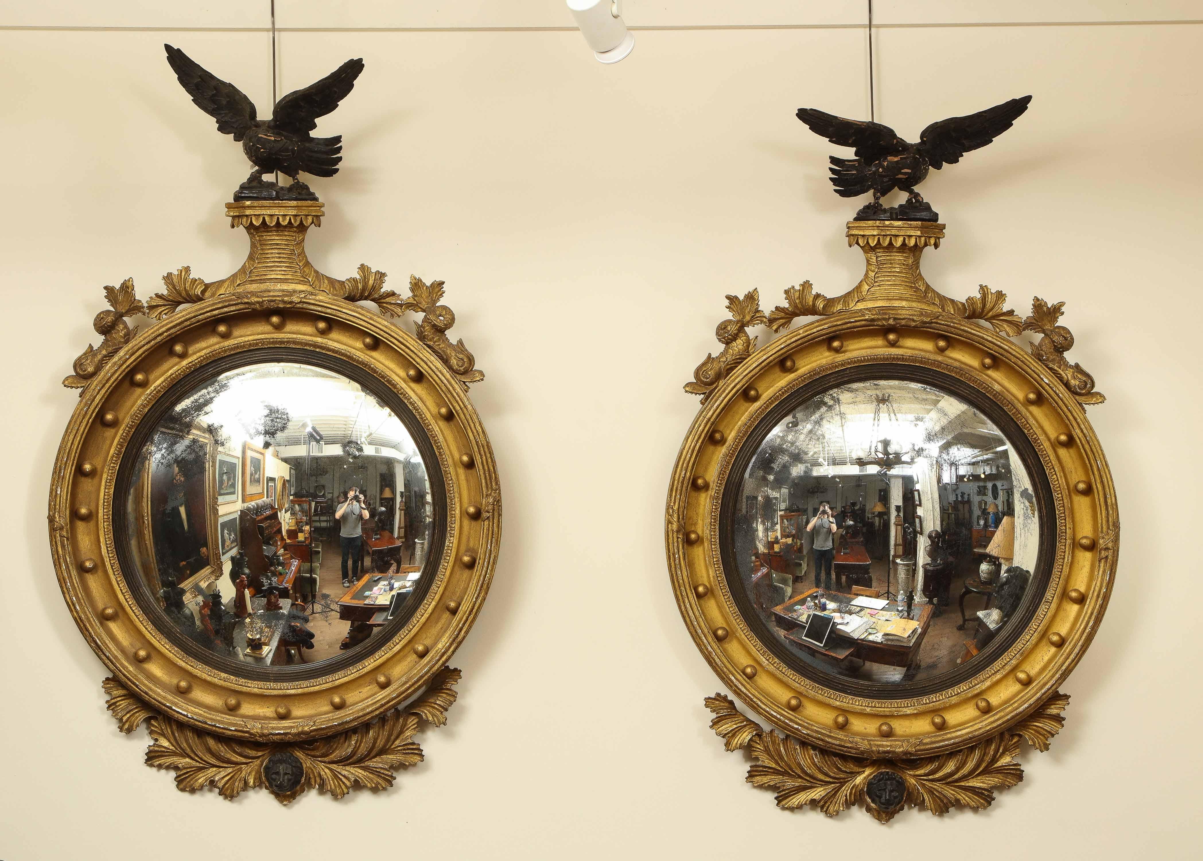 Two early 19th century English convex mirrors with eagles facing left and to the right. Dexter and Sinister.