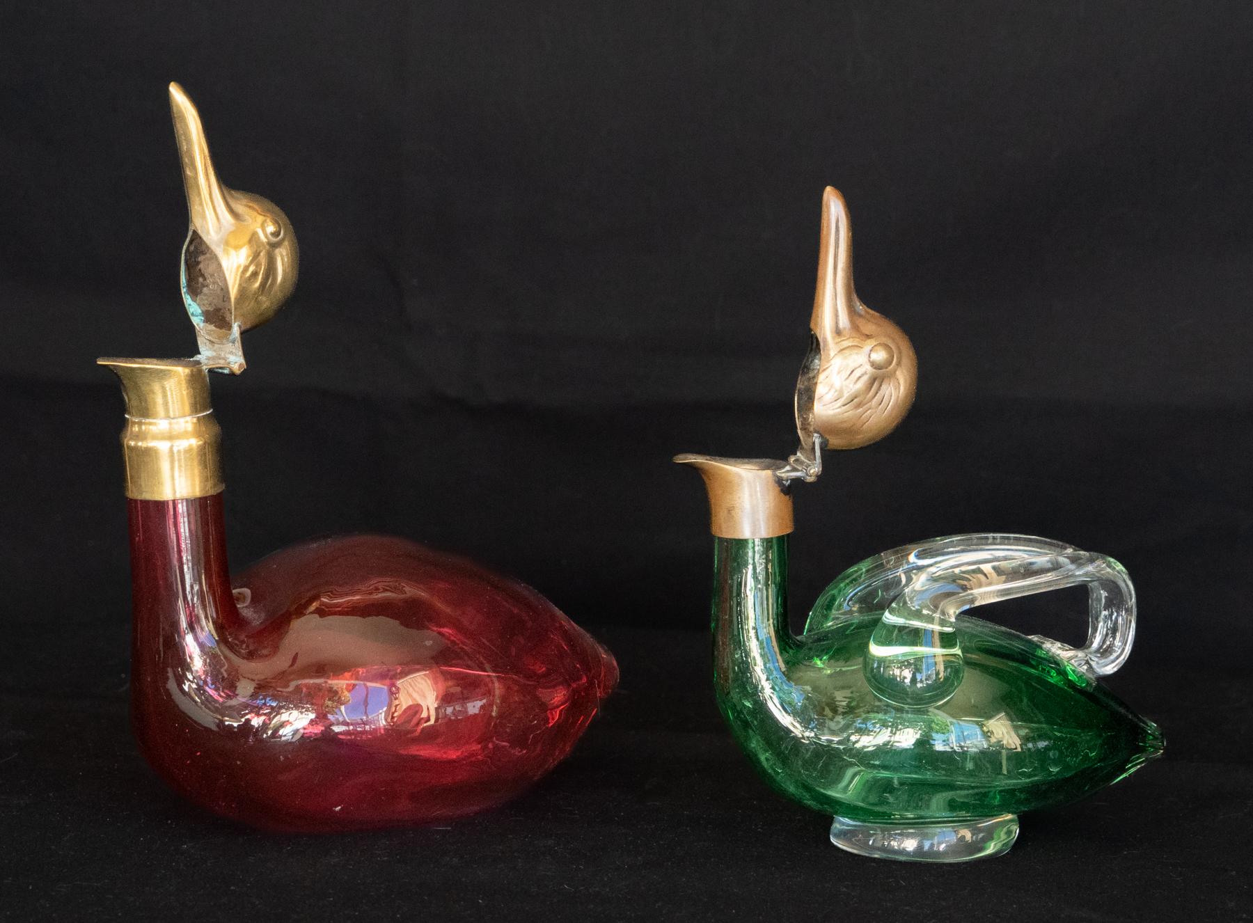 Two early 20th century Austrian decanters in the form of ducks, circa 1920
Two decanters (large/small), smaller with handle and larger without. Good clear colors. The brass heads, once silvered, with beaks that open for a pour.
Perfect for Port