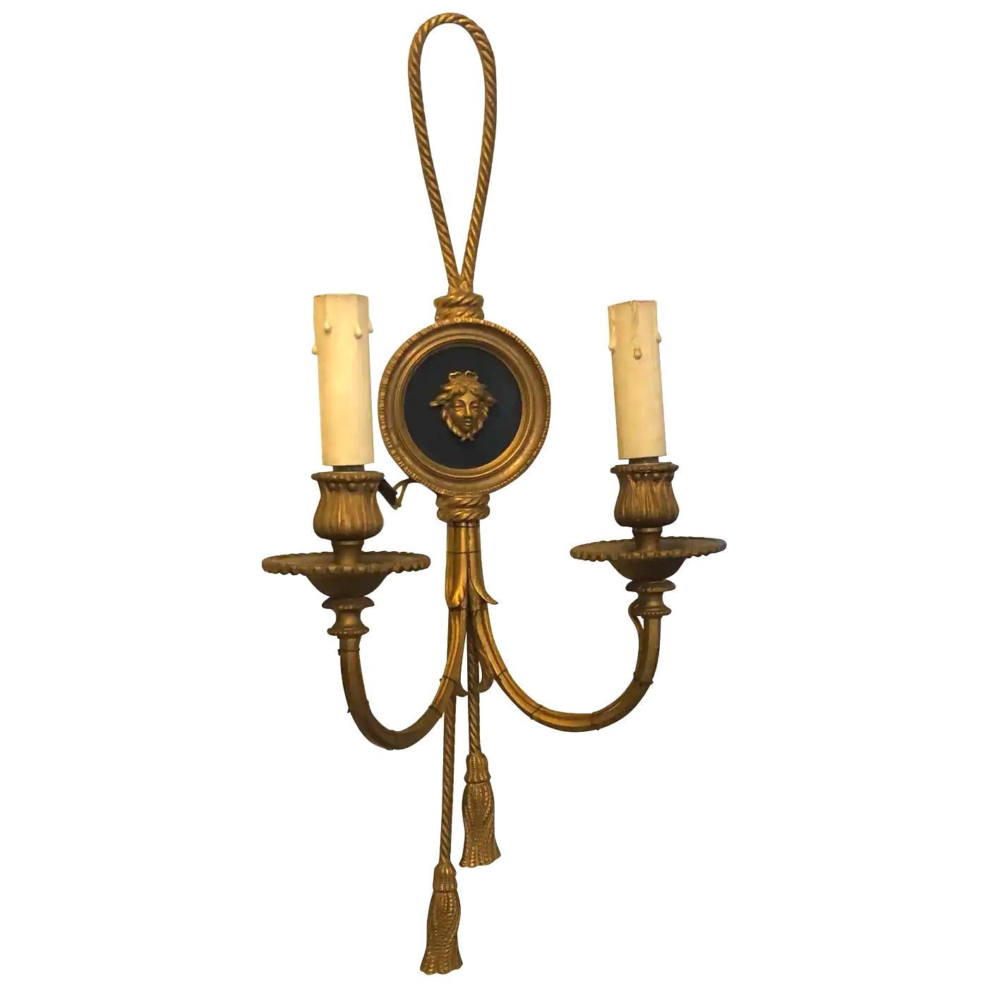 Two Italian wall sconces made in early 20th century, gilded bronze is in perfect conditions, they need regular e14 bulbs and work 110-240 volts, electric wire is external. They are decorated with a Medusa. The Gilded Bronze Wall Sconces are
