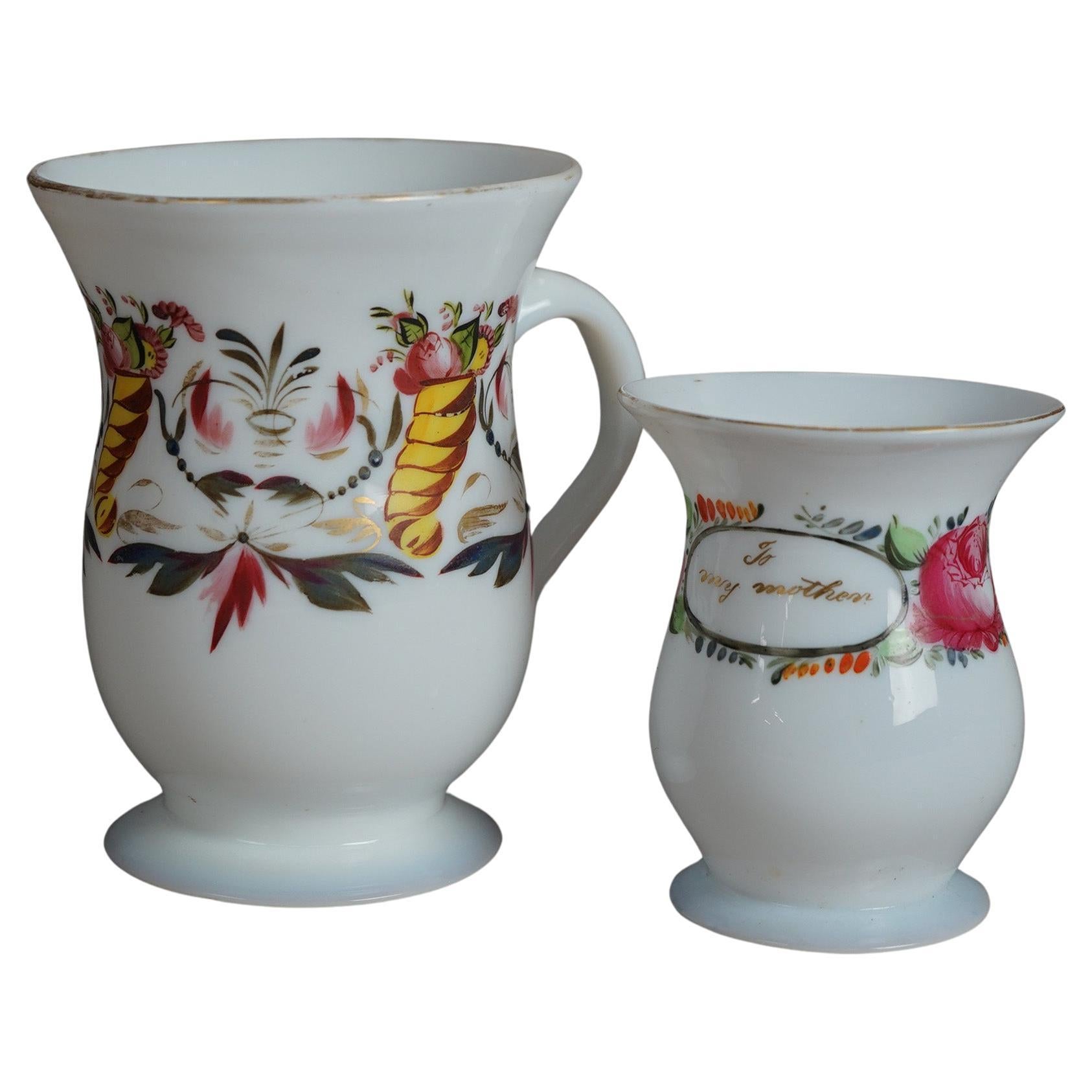Two early antique opaline glass mugs offer hand enameled and gilt decoration, 18th century

Measures - Smaller 4.25
