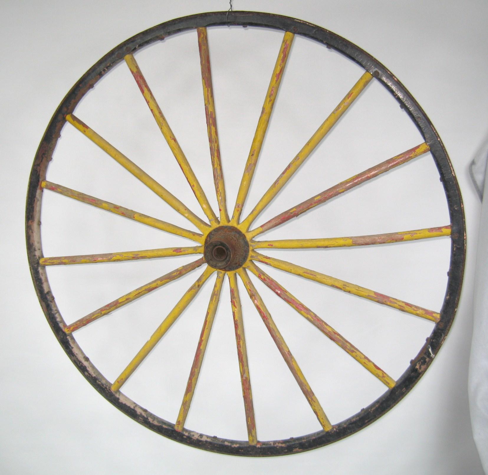 Early set of large wood wagon fire engine wheels, great yellow and hits of red paint showing.