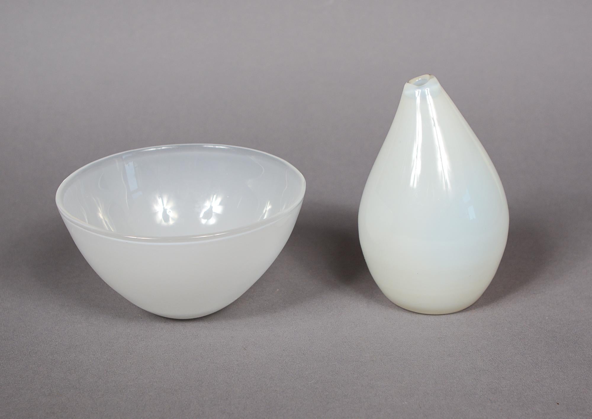 Two early designs by Tapio Wirkkala for Iittala of Finland. These consist of a vase model number 3287 and a bowl model number 5023. They first appeared in the Iittala catalog in 1948. They are both cased opalescent glass. The vase and bowl are