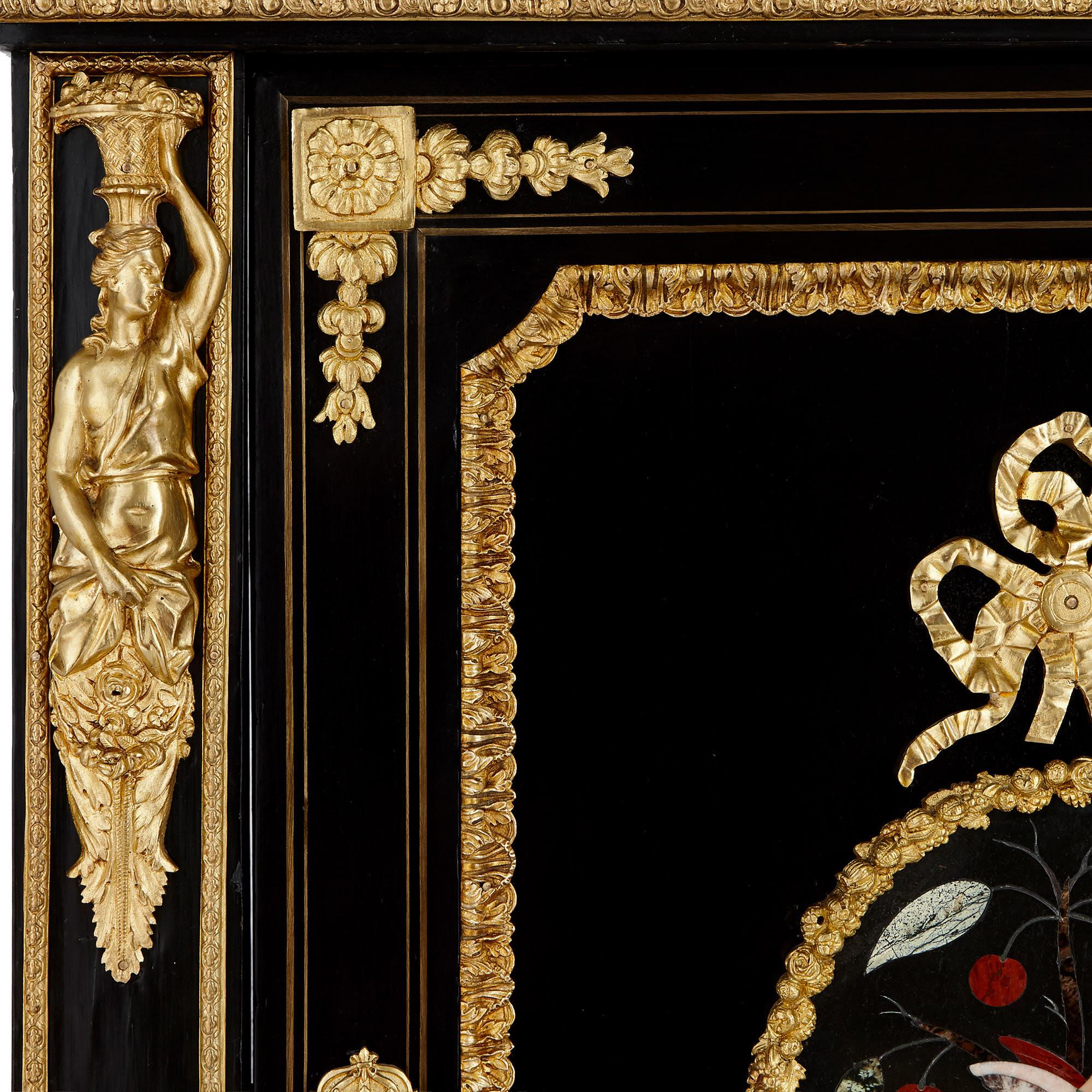 These elegant ebonised wood cabinets feature beautiful central ‘Pietra Dura’ panels. Italian for ‘hard stone’, Pietra Dura panels are composed of a variety of gemstones and marbles, which have been carefully selected, cut and fitted together. This