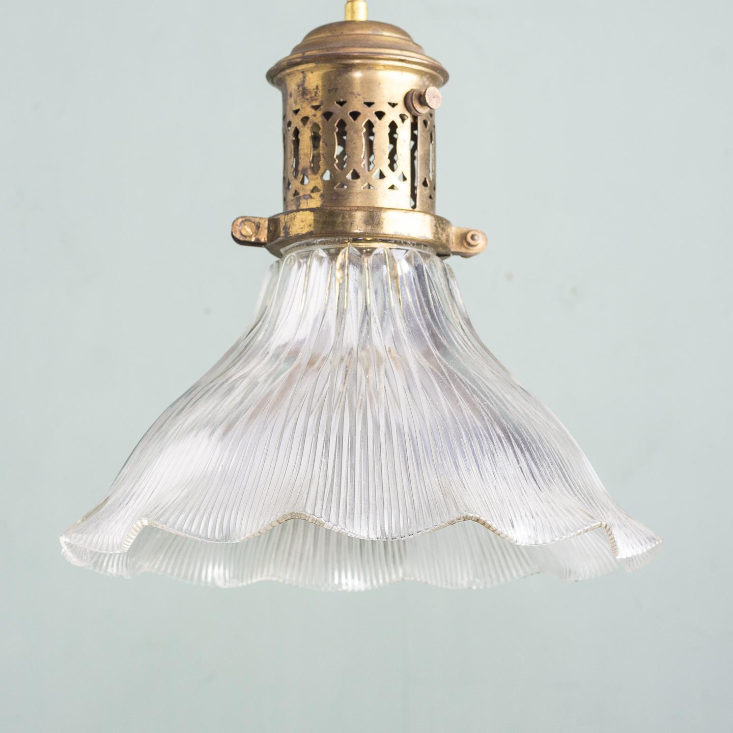 Two Edwardian Holophane pendant lights, the original pierced brass galleries with adjustable mechanism, re-wired.