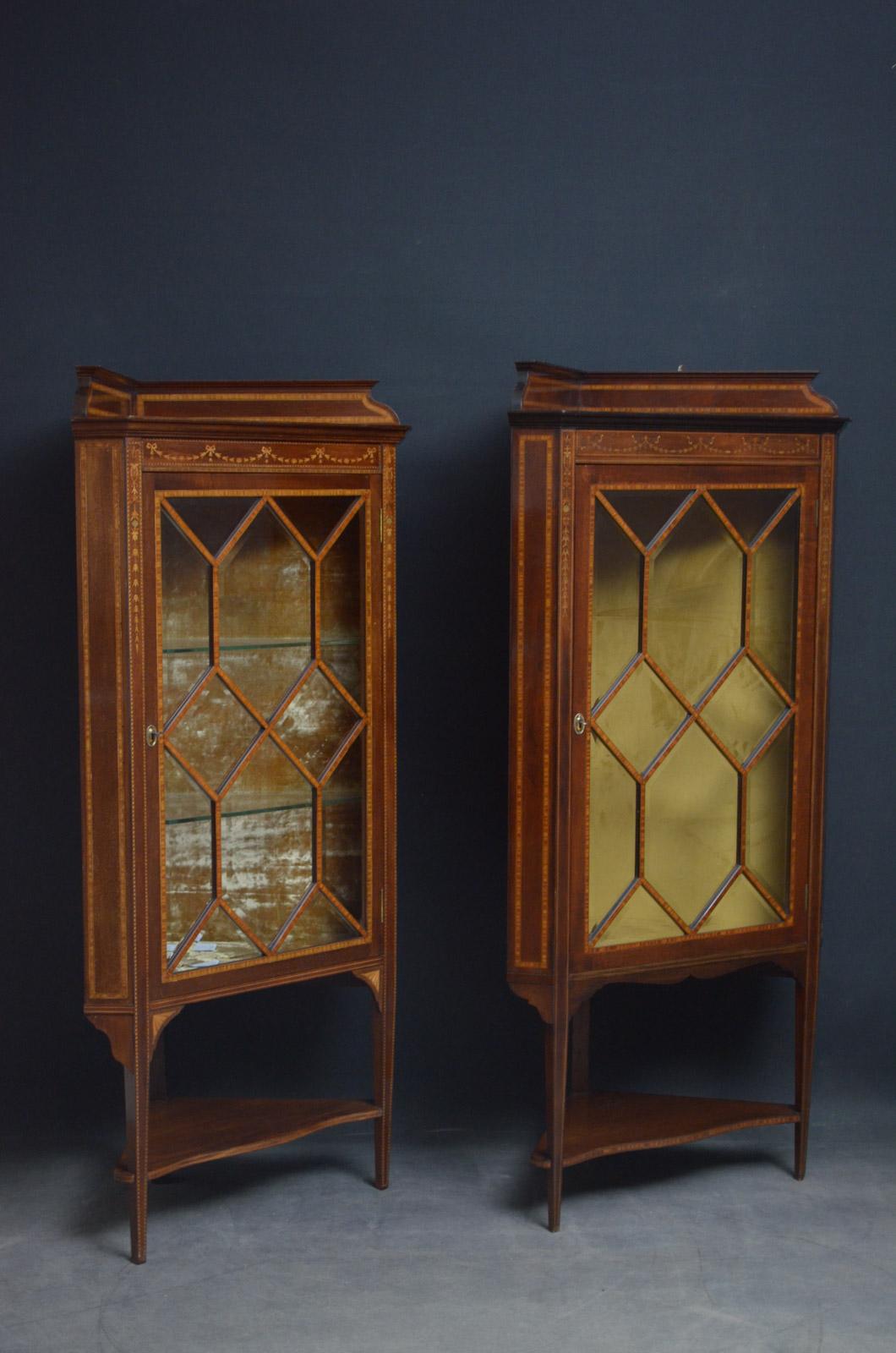 Sn4477 / Sn4647

Matched pair of fine quality Edwardian mahogany corner china cabinets, each having shaped and inlaid upstand above neoclassical inlays to frieze and glazed door with bevelled edge glass panels and crossbanded frame fitted with