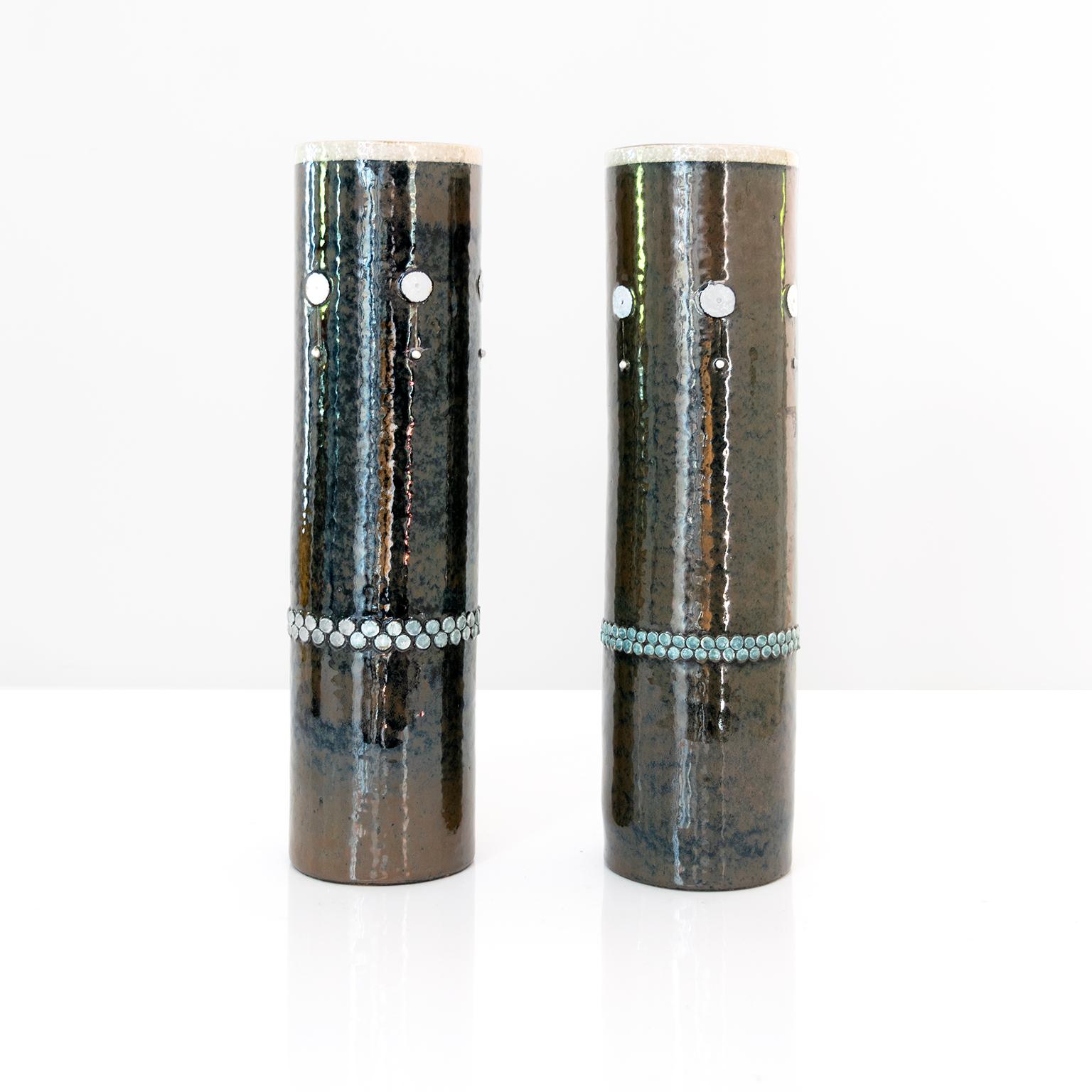 Two elegant tall Scandinavian Modern midcentury ceramic studio vases with raised elements and finished in a dark glaze by designer Sylvia Leuchovius for Rorstrand, Sweden.

Dimensions: Height: 14.5” Diameter: 4”.
