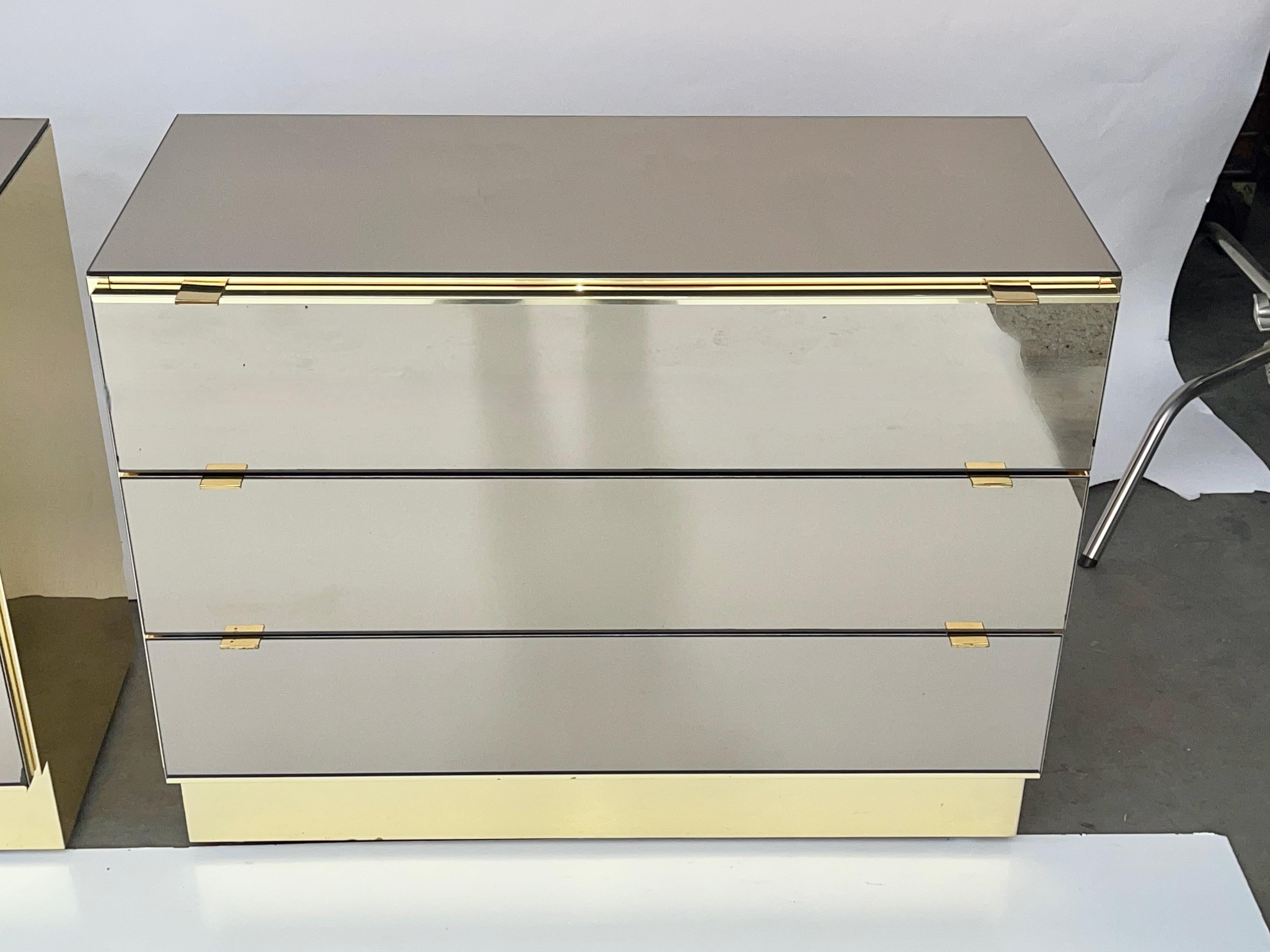 Two companion cabinets designed by O. B. Solie for Ello Furniture Manufacturing Co. clad in smoke tinted mirrored glass and polished brass tone anodized aluminum. I believe these are from their Moods II collection.
Chest of three drawers and a