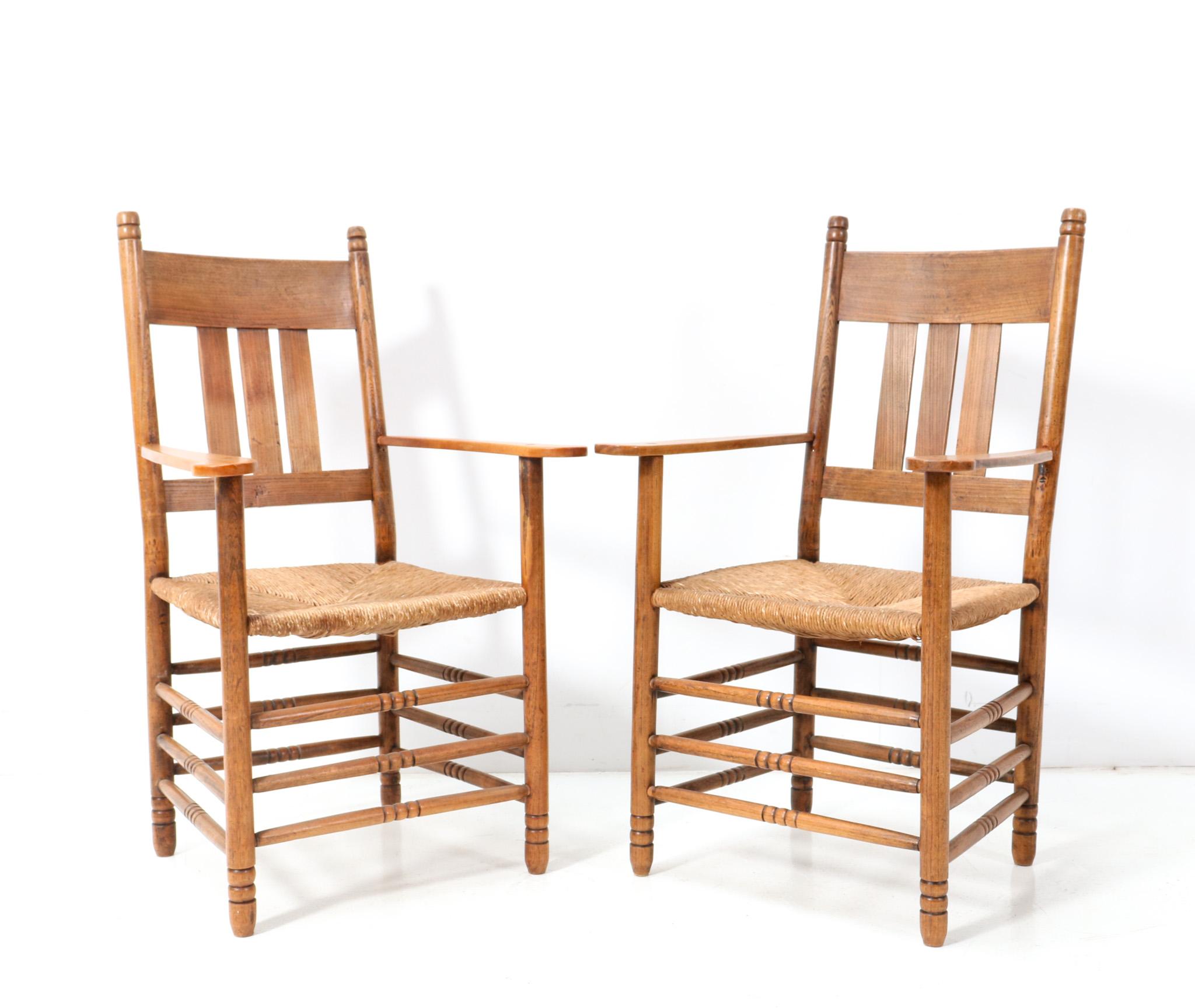 Stunning and rare pair of Art Nouveau armchairs.
Design by Willem Penaat.
Striking Dutch design from the 1900s.
Solid elm frames with original rush seats.
This wonderful pair of Art Nouveau Brabant armchairs by Willem Penaat is in very good