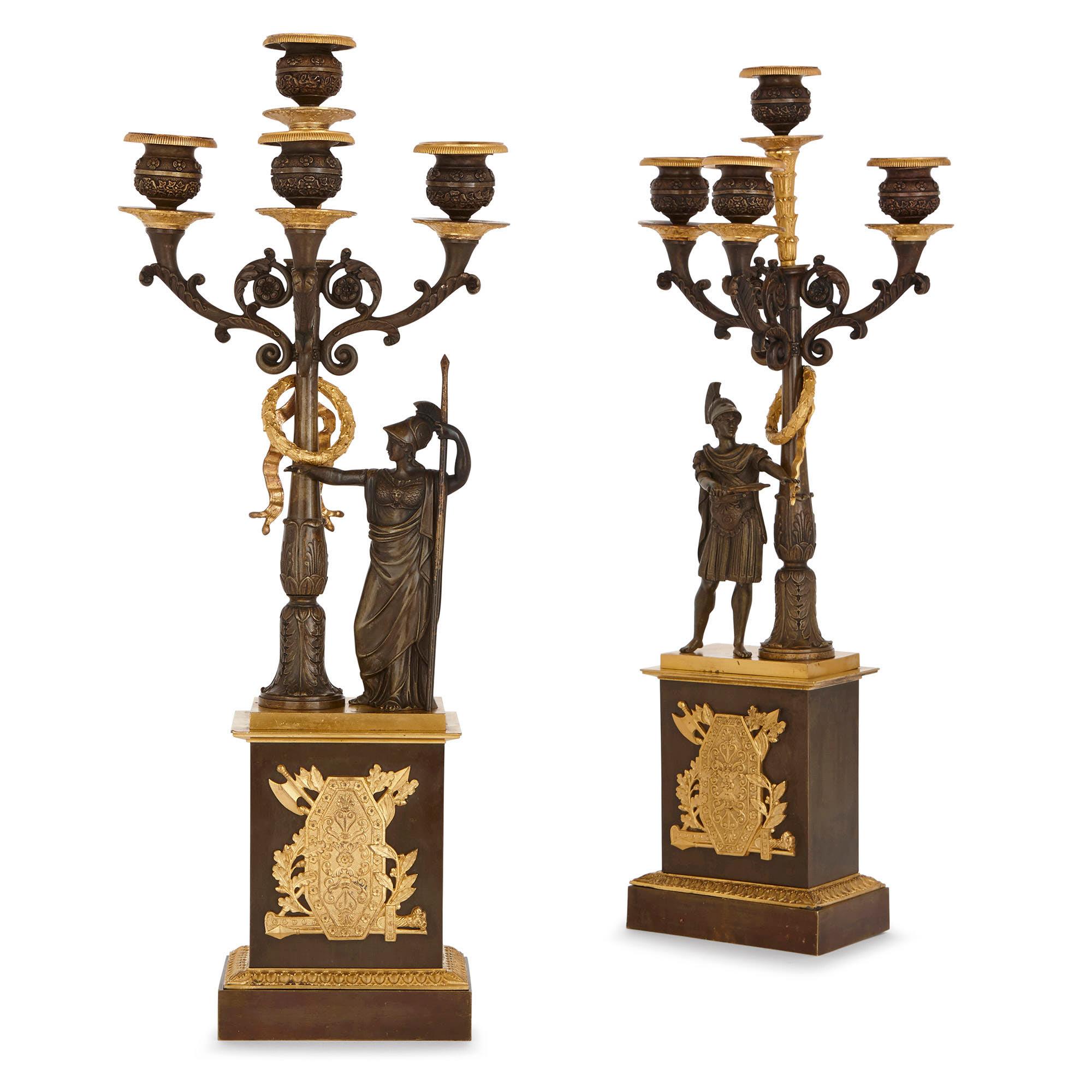 This majestic pair of gilt and patinated bronze candelabra are designed in the Empire style, which was popularized under Napoleon I (1769-1821). The art of the Empire period (1804-1814, 1815), when Napoleon was in power, often focused on the