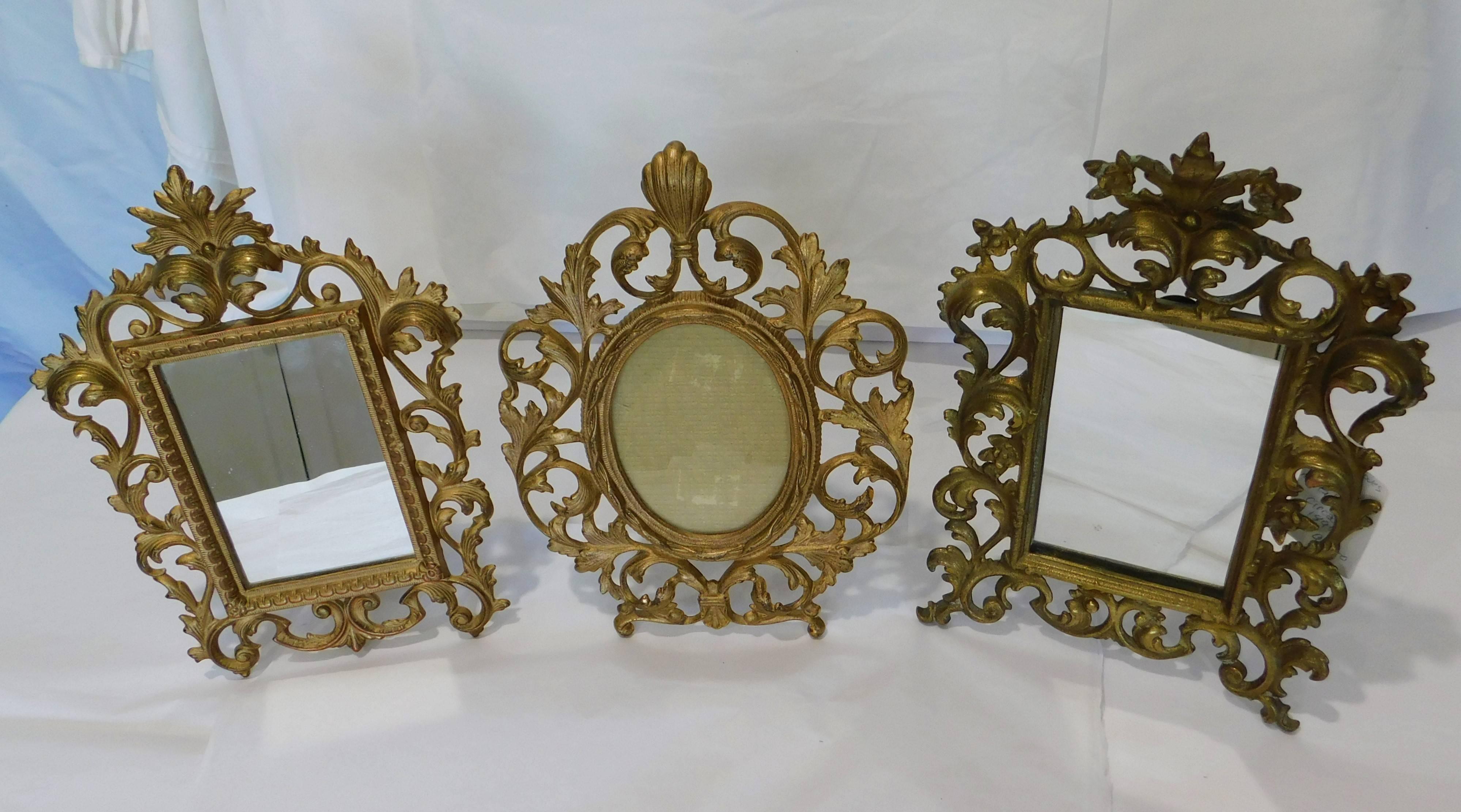 These two English gilt bronzed table vanity mirrors are in very good condition and are in the Rococo style.
Measure: Two rectangle mirrors measure 8 x 11.25 x 1.25 inches and 8 x 11.50 x 3.25 inches. The oval frame is 8.5 x 11 x 4 inches and can be