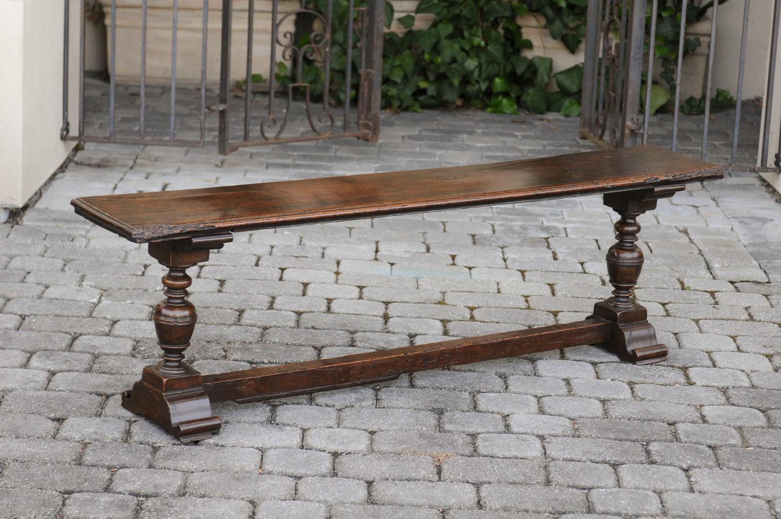 Two English Georgian period walnut benches from the early 19th century, with turned legs and cross stretcher. They are priced and sold individually. Born in England during the early years of the 19th century, each of these two walnut benches