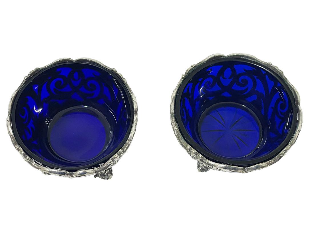 Two English silver plated salt cellars by Henry Wilkinson,  Sheffield 1830-1872

Two large silver plated with blue glass salt cellars. The cellars are made by Henry Wilkinson & Co, Sheffield. The hall mark dates from 1830-1872, Sheffield,