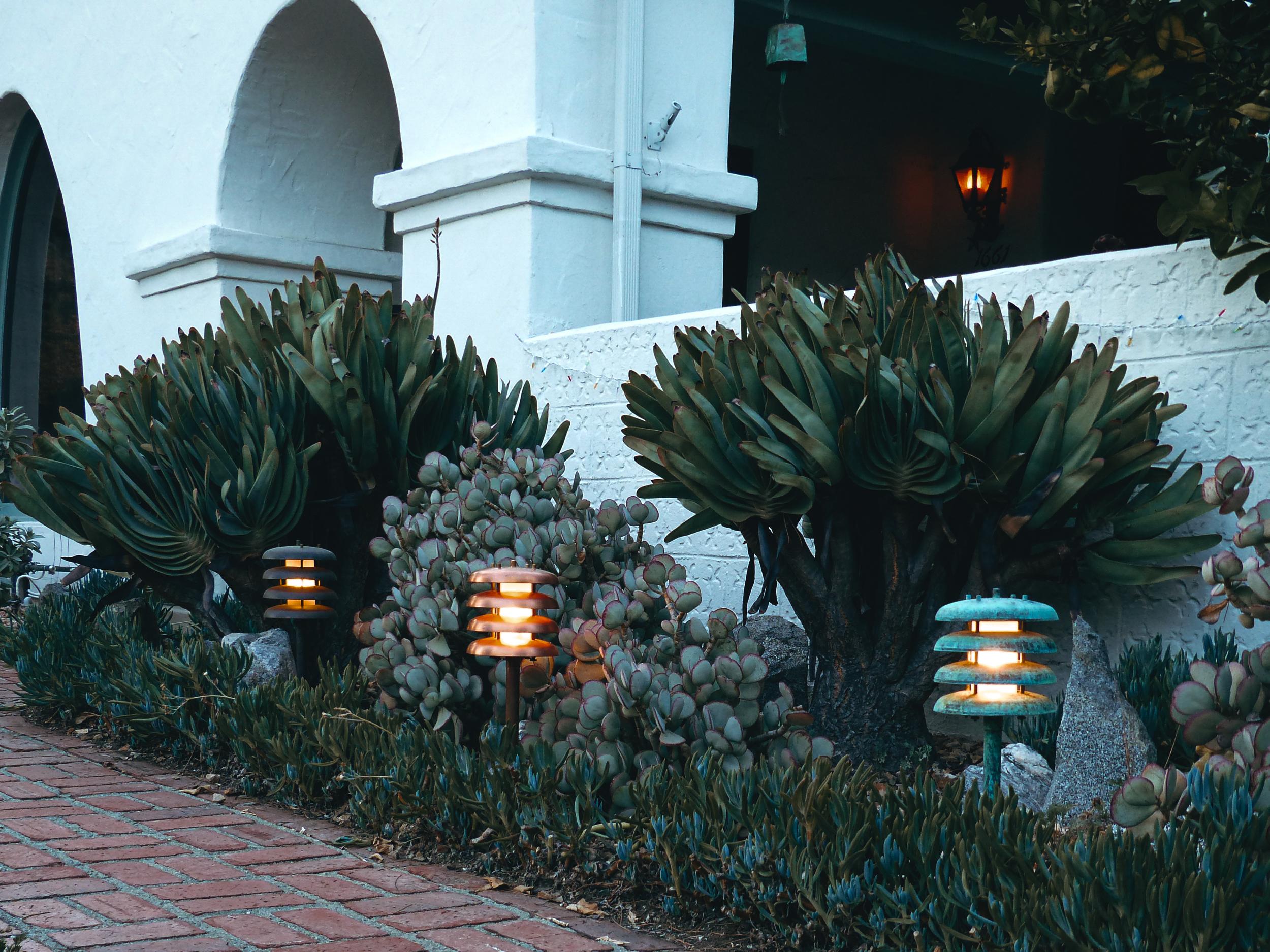 Two Enlighten 'Gibson' Outdoor Bollard Light in Raw Copper. Executed in raw unlacquered and unpolished copper. A highly refined fixture reminiscent of the designs of Poul Henningsen that brings bold, sculptural, yet glare-free illumination to