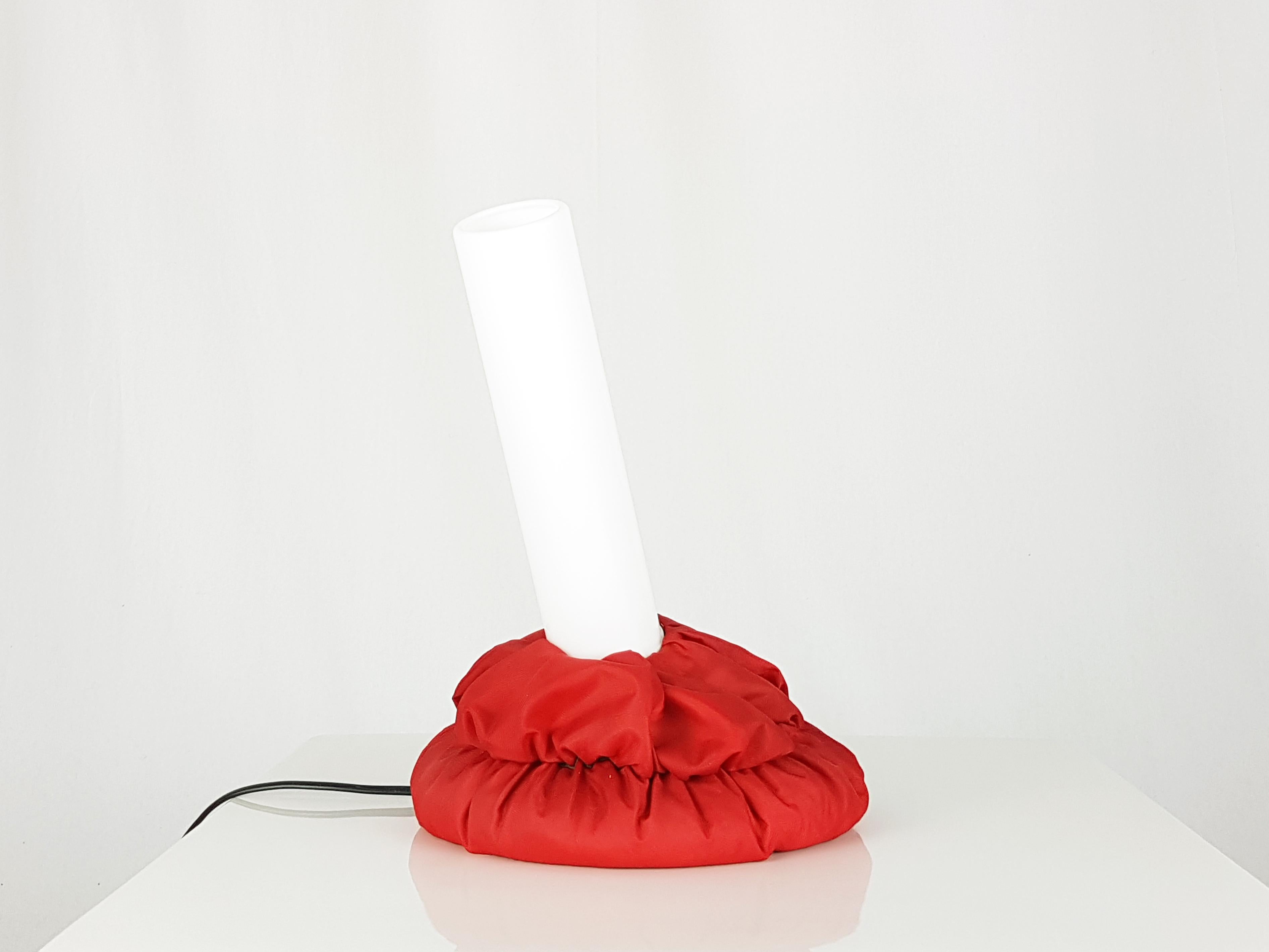 The base is a synthetic fabric bag filled with small plastic pellets. The lampshade is an orientable perspex cylinder. Very good condition: the two lamps are in excellent condition, but both have an imperceptible cut/hole on the fabric as shown in