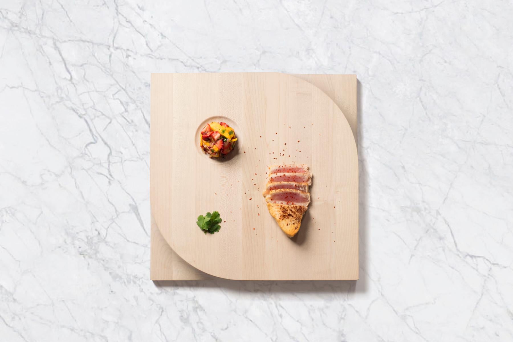Beauty meets function. This two-sided cutting board is made with European maple butcher block and carved at the corners with an ergonomic shape for easy lifting and handling. It’s a dinner party staple accommodating your laborious food preparation