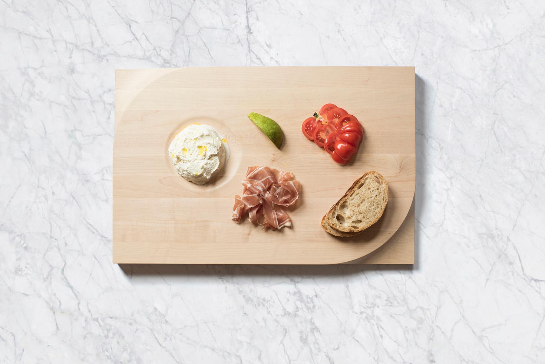 Beauty meets function. This two-sided cutting board is made with European maple butcher block and carved at the corners with an ergonomic shape for easy handling. It’s a dinner party staple accommodating your laborious food preparation on the broad,