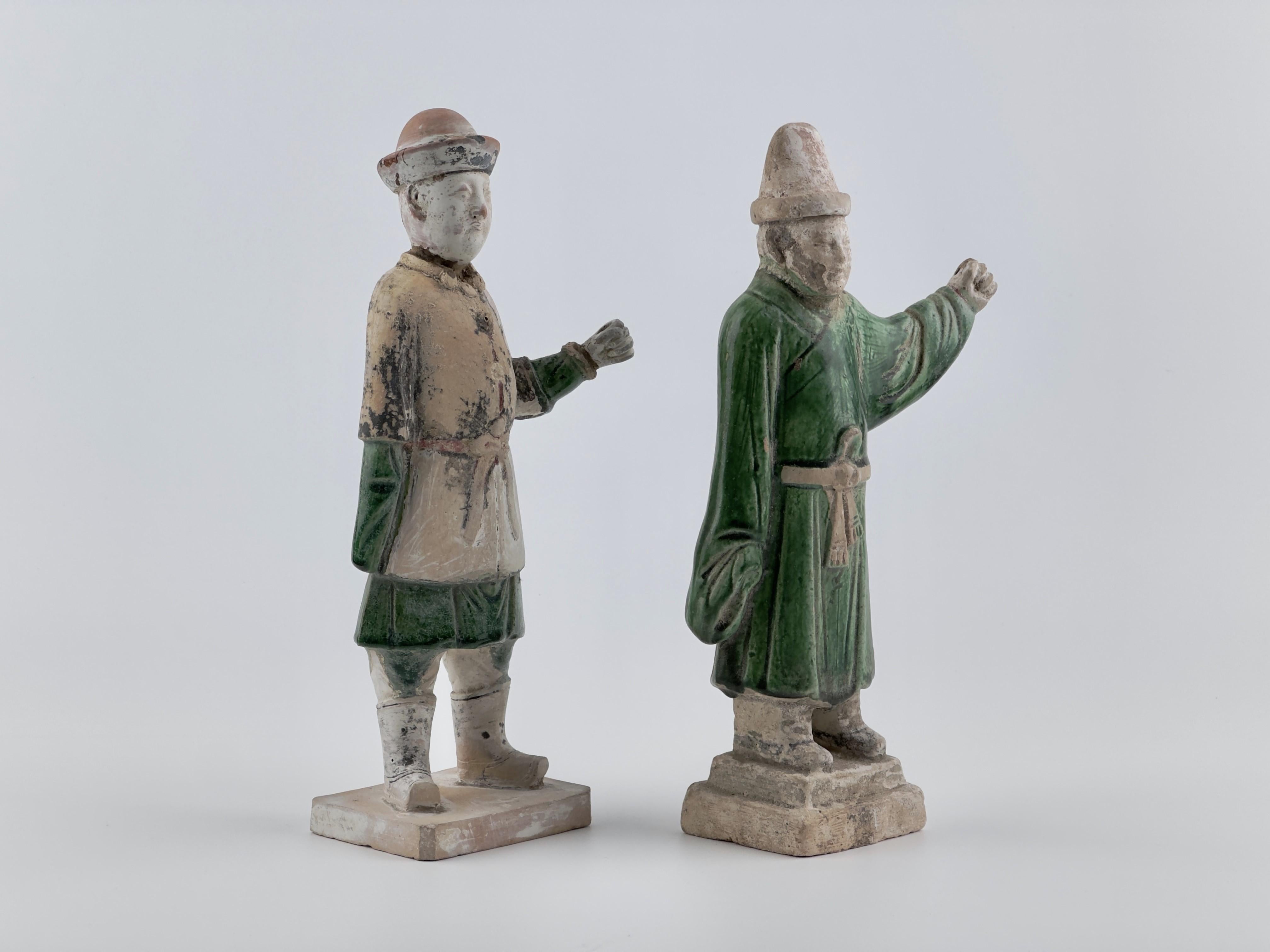 Statues of attendants crafted from terracotta, featuring glazes in green, Set on rectangular bases.

Period: Ming Dynasty 
Medium: Glazed Pottery
Type: Figure
Condition : Excellent(It has soil on it, which is presumed to be evidence of