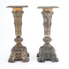 Two finely crafted silver and gold metal columns with geometric motifs