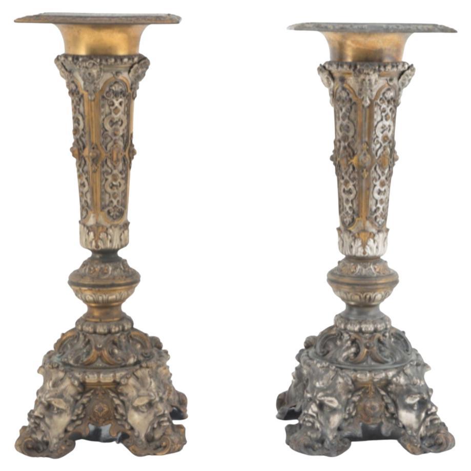 Two finely crafted silver and gold metal columns with geometric motifs For Sale