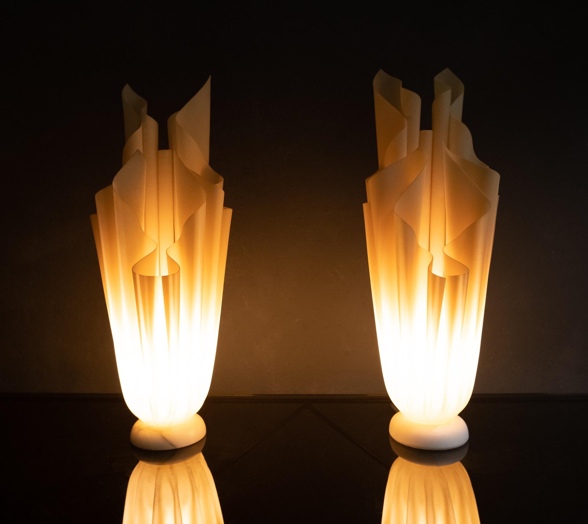 Two wonderful table lamps. Creme color resin. On a white marble base design by Georgia Jacob France 1970. Model ''Althena'' when lit it gives a warm nice light. Very good condition.