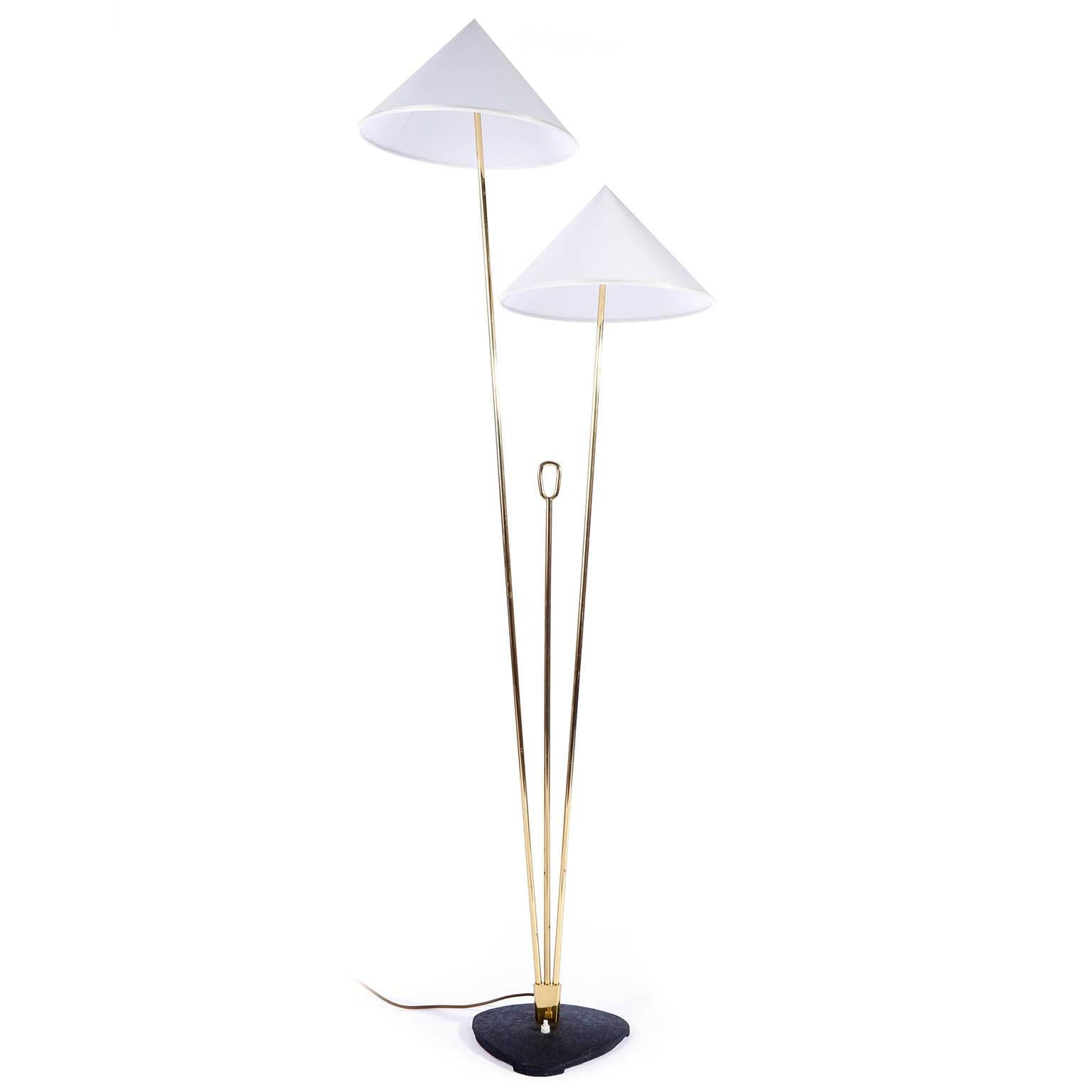 A brass floor lamp with cone shaped lampshades by Rupert Nikoll, Vienna, Austria, manufactured in midcentury, circa 1960 (late 1950s or early 1960s).
The stand is made of two brass rods in different lengths and in between is a shorter brass rod with