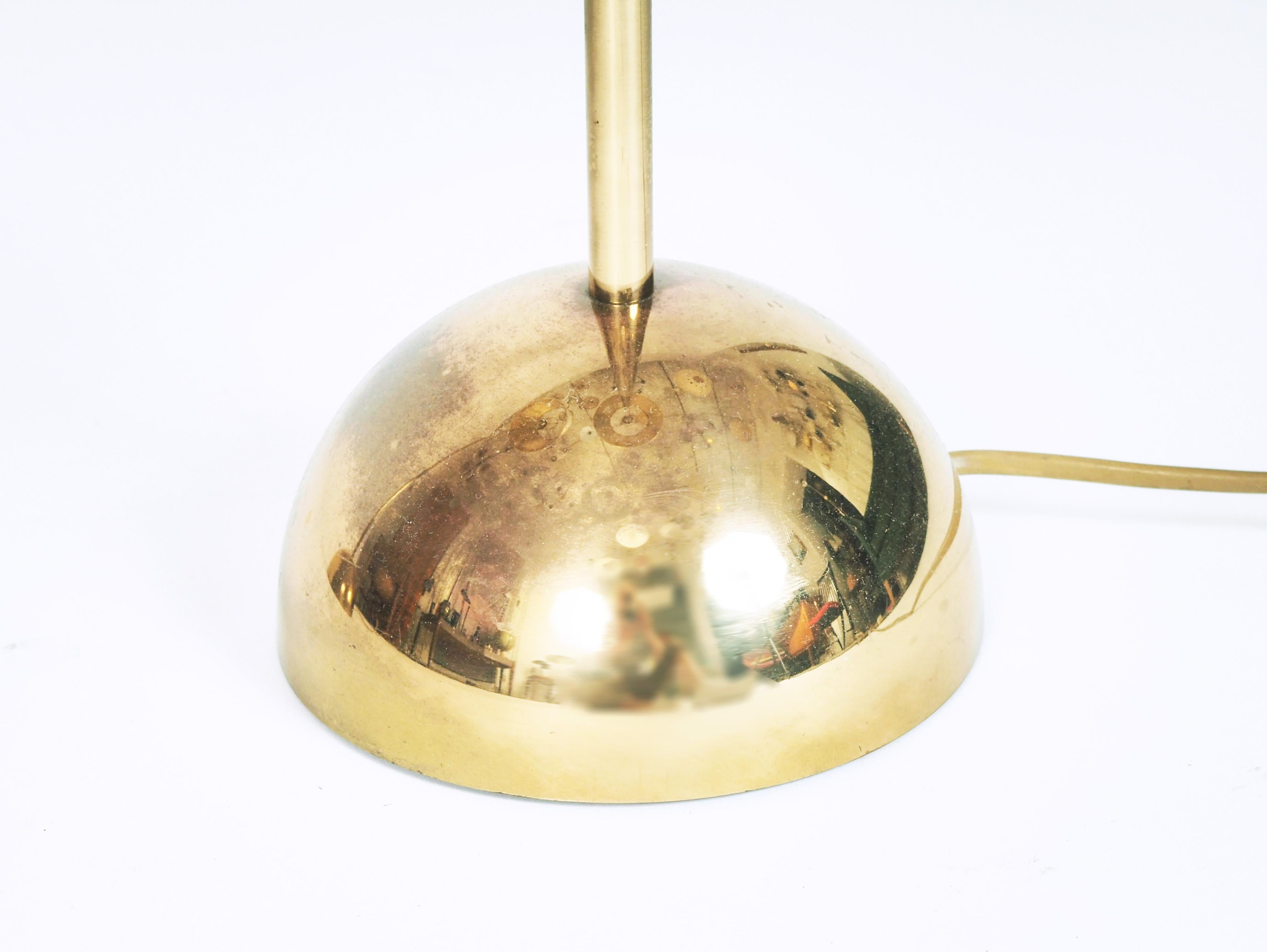 A pair of floor lamps in brass made in Sweden at Bergboms during the 1970s. Original lampshades with golden inside.