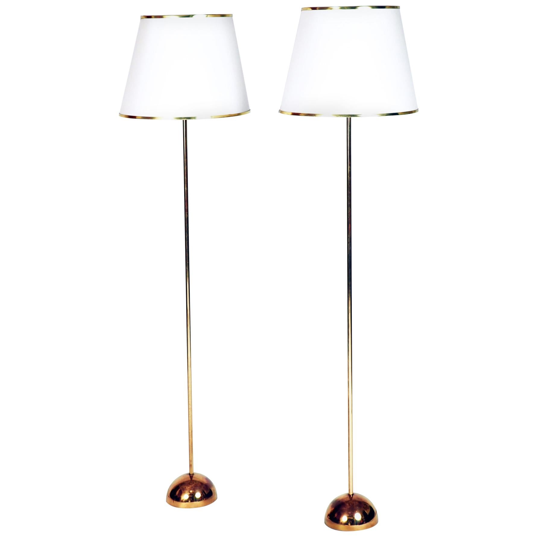 A Pair of Floor Lamps in Brass with original shades. Made by Bergboms, Sweden