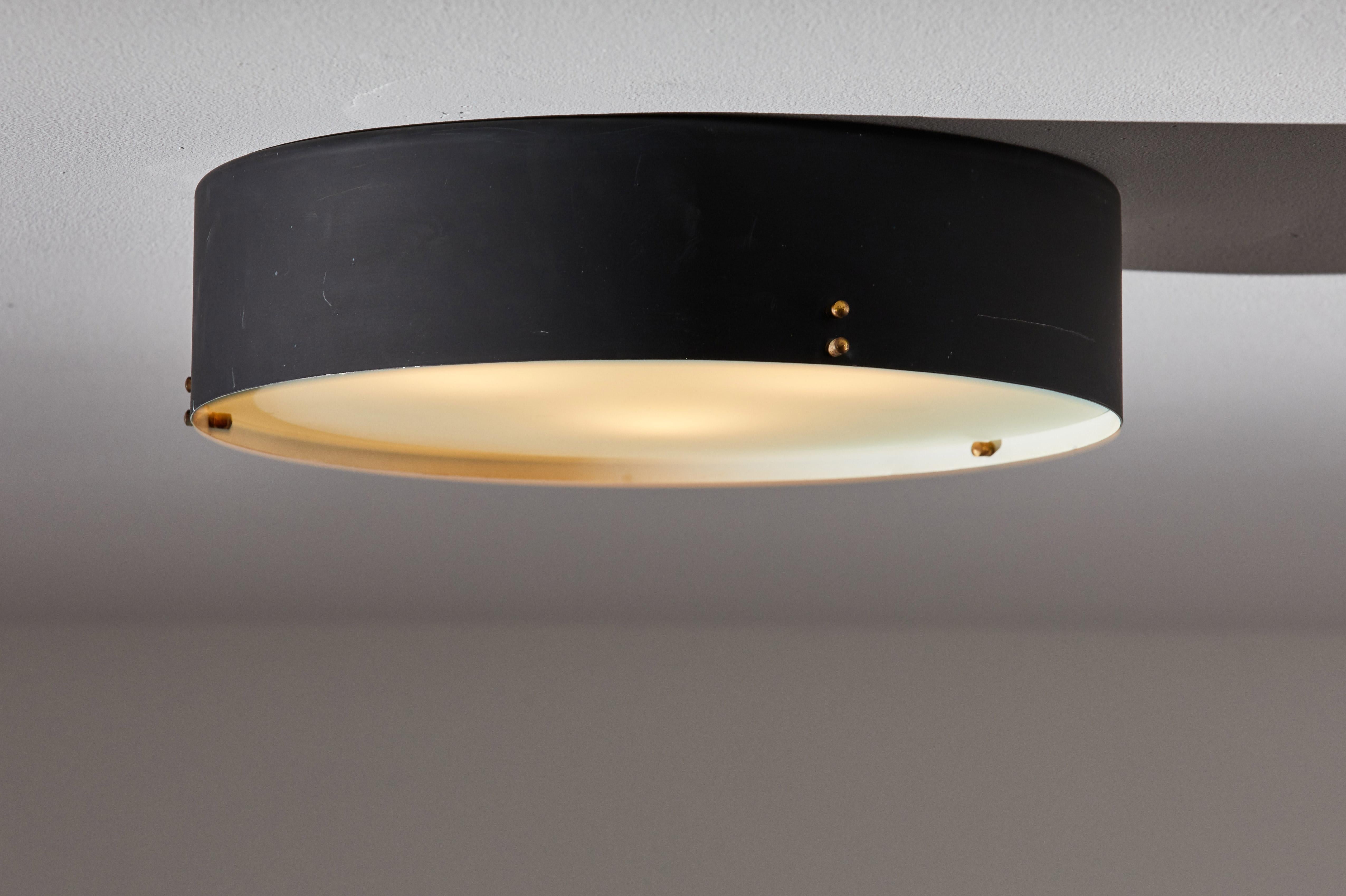 Single flush mount ceiling light by Bruno Gatta for Stilnovo. Designed and manufactured in Italy, circa 1960s. Enameled metal, glass, brass hardware. Rewired for U.S. junction boxes. Takes three E27 European candelabra sockets, 50w maximum each.