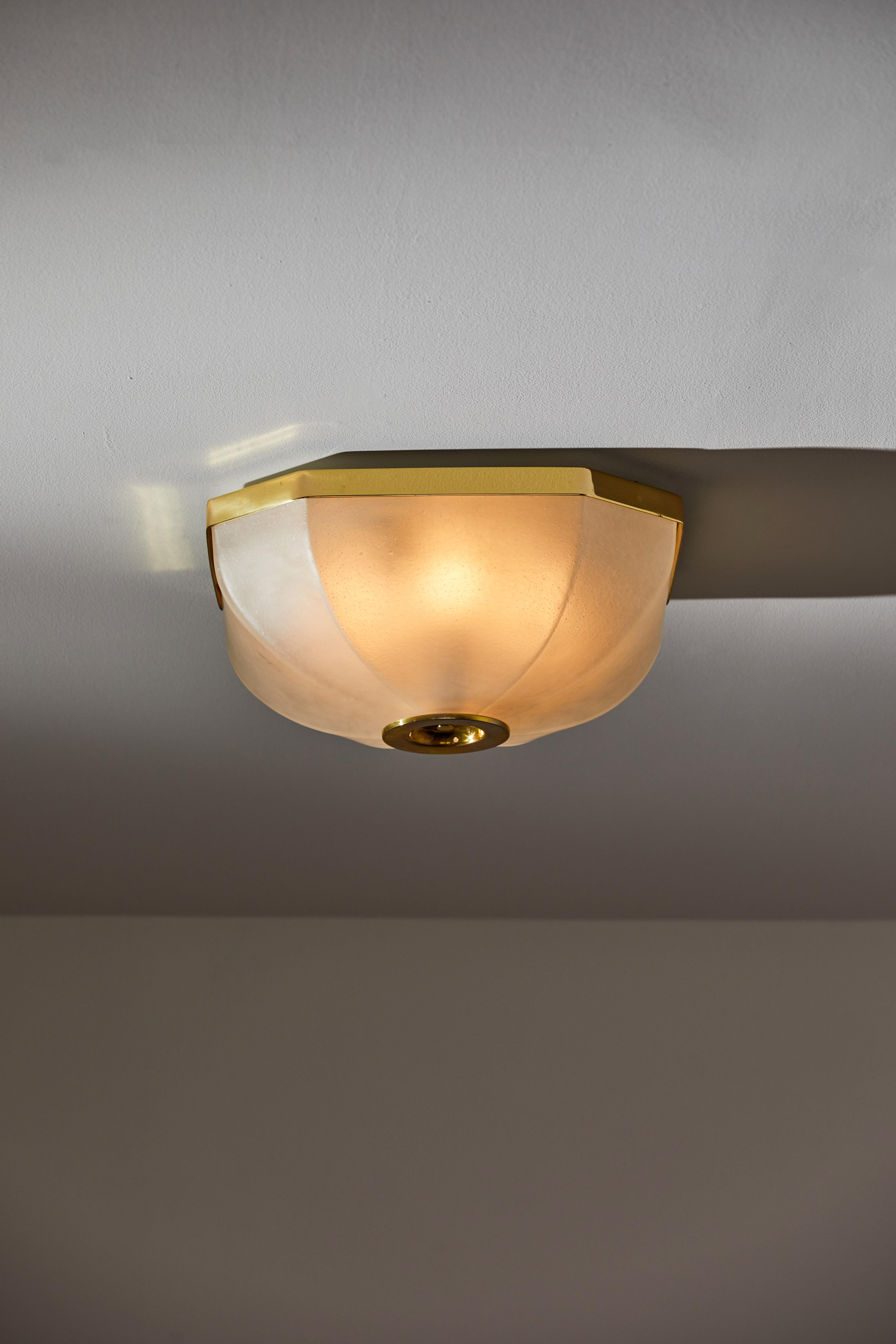 Flush mount ceiling lights by Lumi. Designed and manufactured in Italy, circa 1950s. Glass, brass. Rewired for U.S. standards. We recommend four E27 40w maximum bulbs per light. Bulbs are included as a one-time courtesy. Sold individually and not as