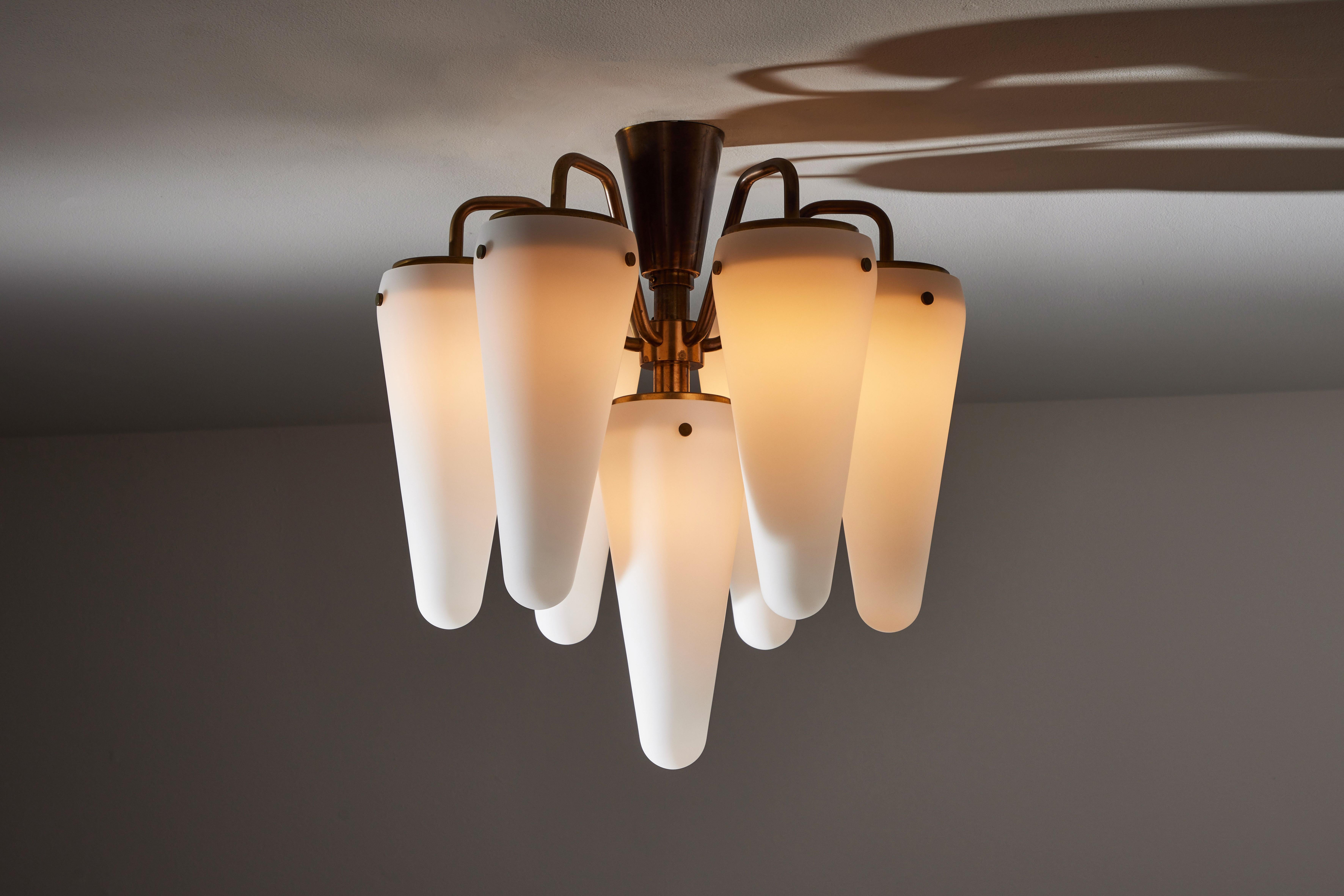 Two flushmount chandeliers by Hans-Agne Jakobsson. Manufactured in Sweden, circa 1960s. Brushed satin glass diffusers, brass armature. Wired for U.S. standards. We recommend seven E27 15w maximum bulbs per fixture. Bulbs provided as a one time