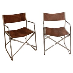 Two folding chairs in chrome and chokolate colored suede