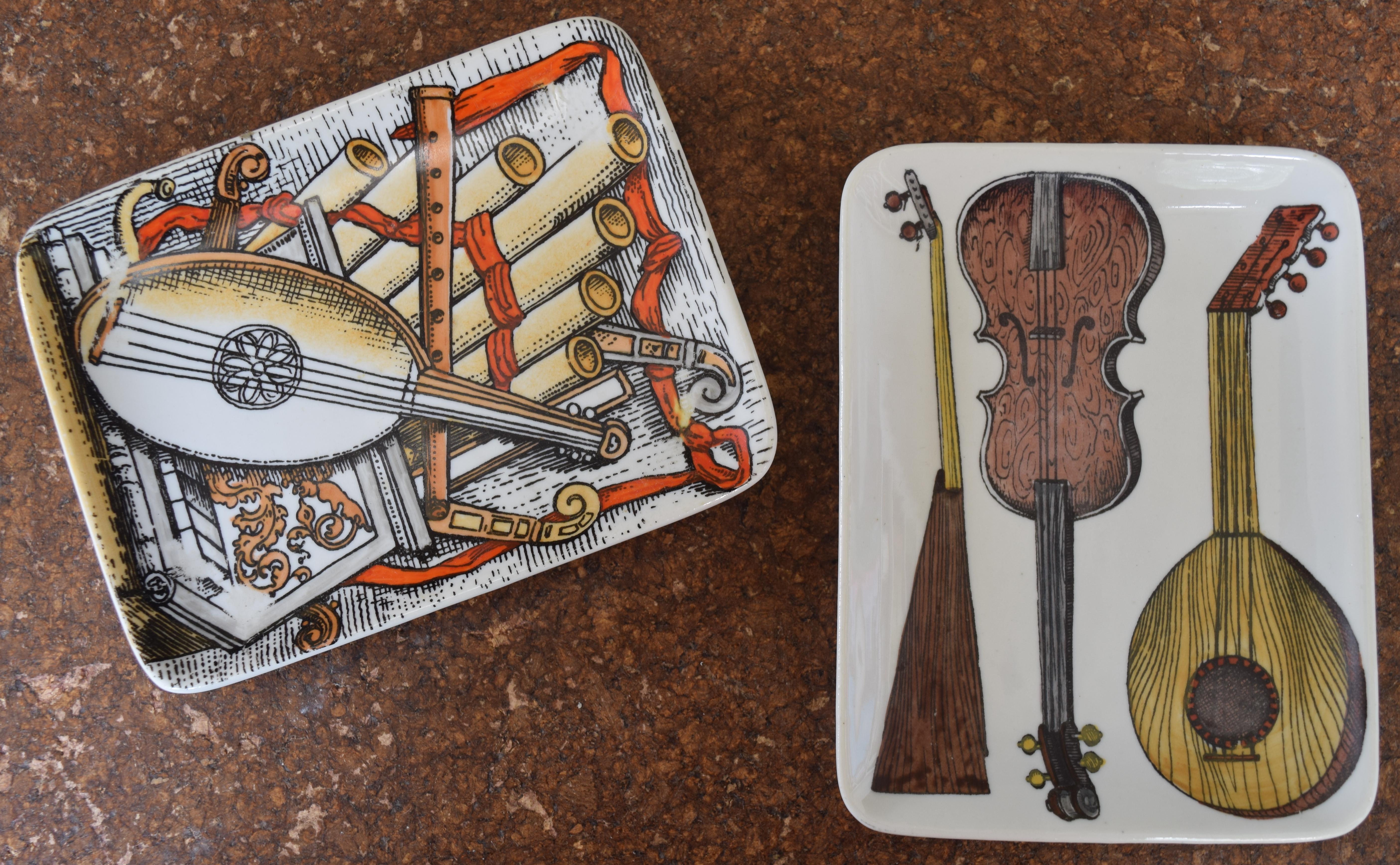 Vintage Fornasetti dishes with musical instrument theme. By Piero Fornasetti and signed to reverse. Price is for both.