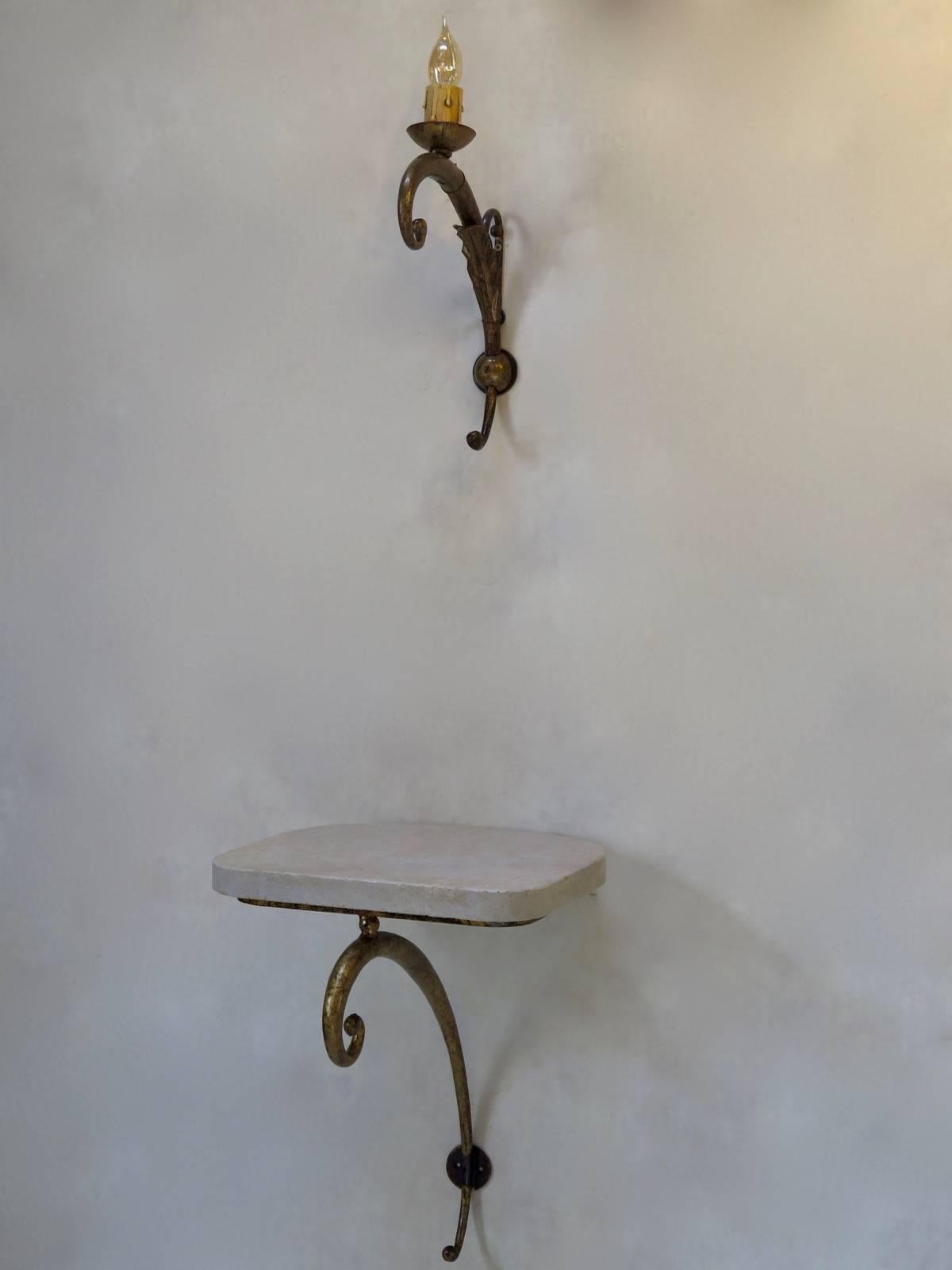 A double pair of wall lights and consoles or wall brackets. The structures are made of gilded wrought iron. The console tops are travertine.

Dimensions given below are for the wall brackets. The sconces measure:

Height 34 cm - 13.38 in
Width
