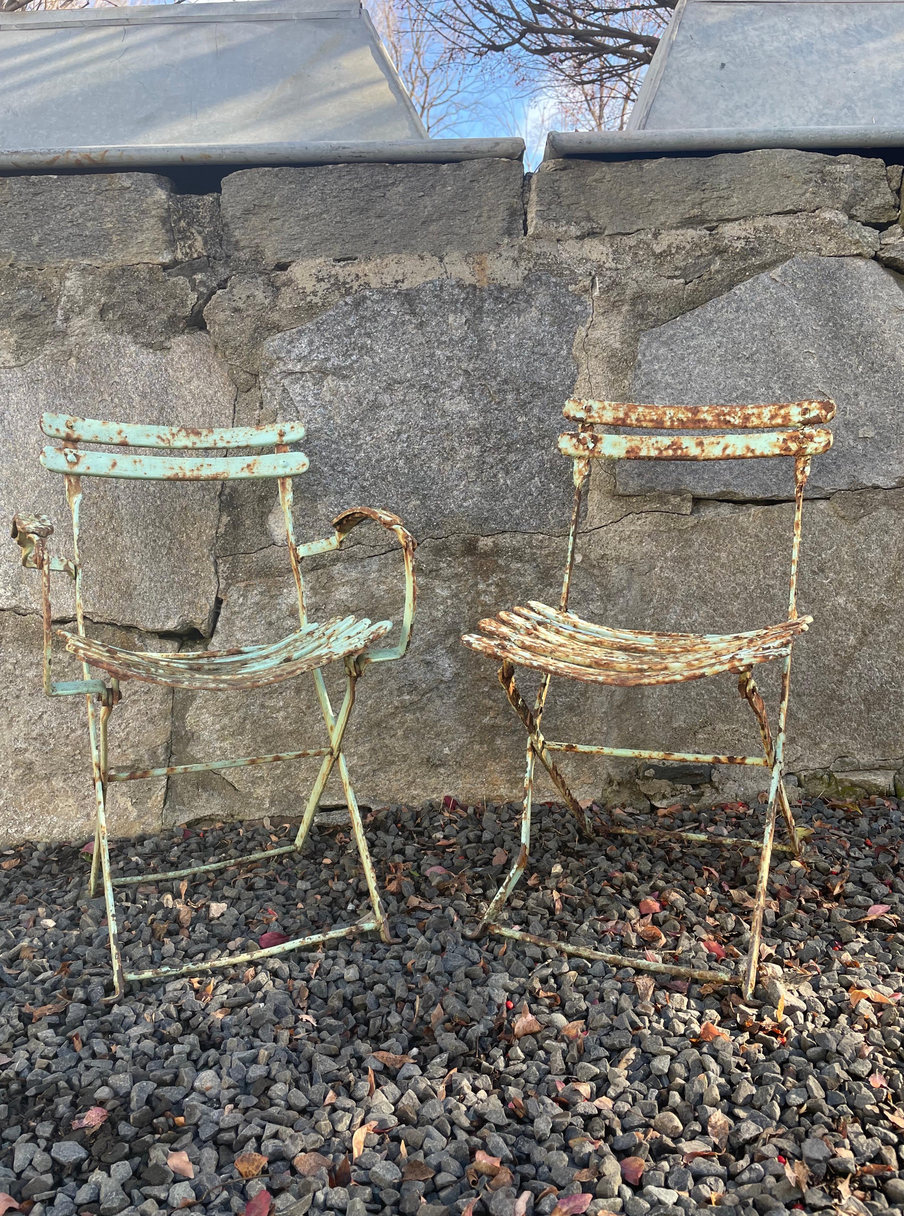 We have had this model of garden chairs before, but have never seen them in a children’s size. Constructed of wrought iron and sporting a beautiful weathered painted patina with pale blue-green paint and a moderate amount of surface rusting, they