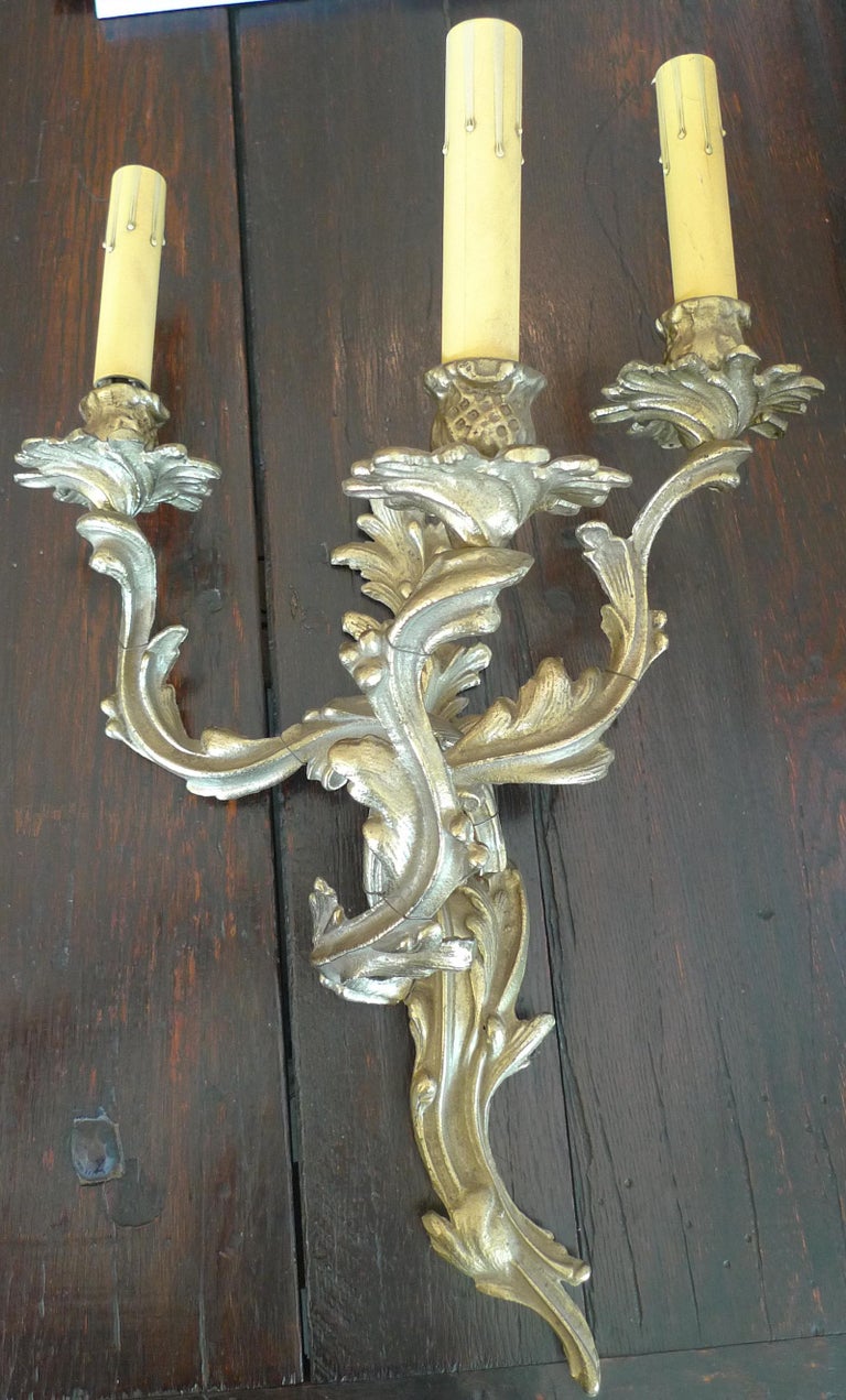 Two French 19th century solid bronze three-light sconces.