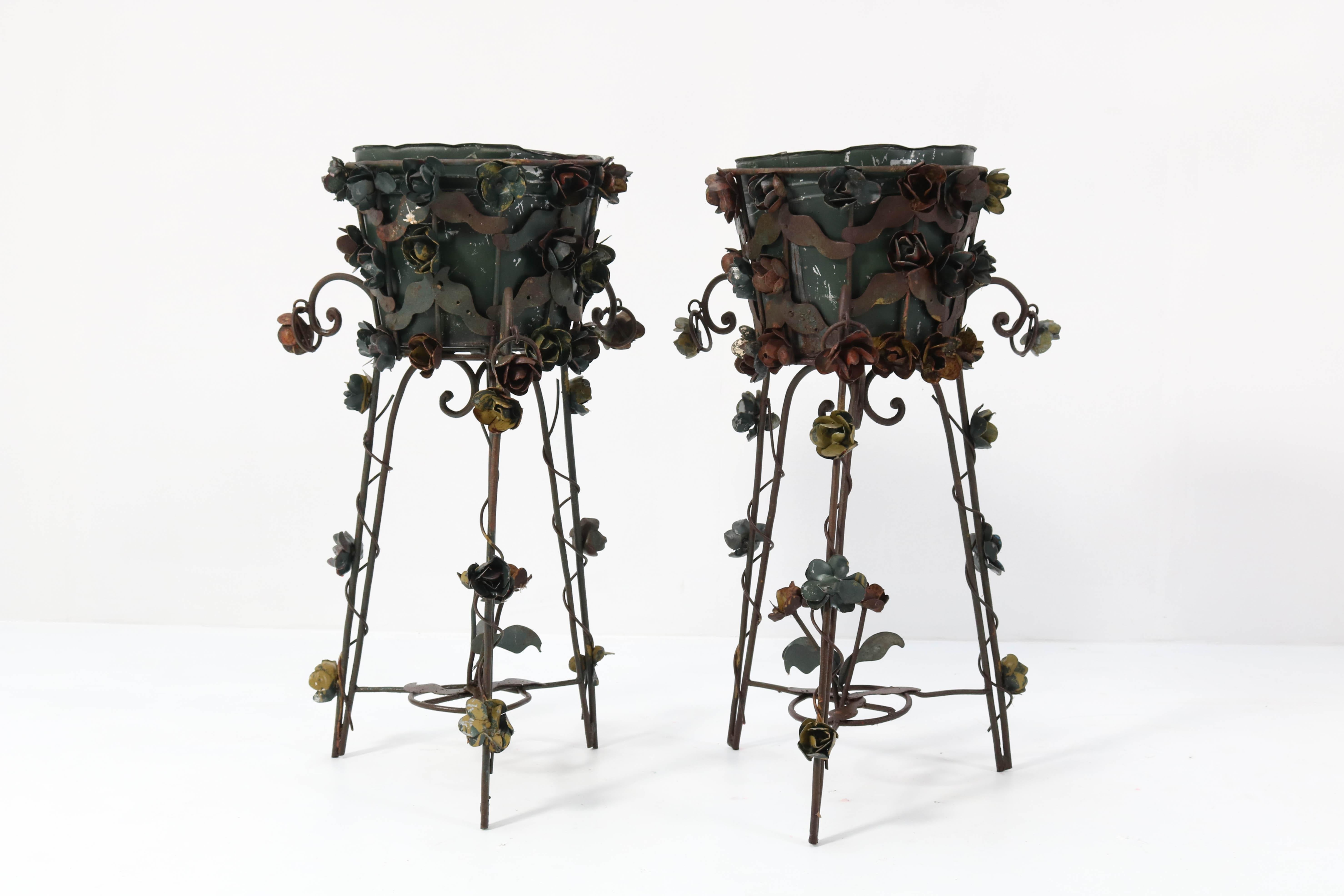 Wonderful pair of Art Nouveau style jardinières or plant stands.
Striking French design from the 1950s.
The wrought iron scrolled base with hairpin legs is covered with beautiful wrought iron
roses and vines.
These decorative pieces with a